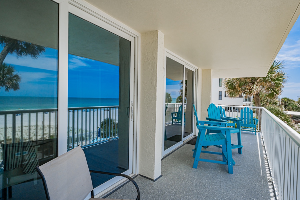 Step onto your private balcony where turquoise waters and soft white sand greet you. Grab a seat in one of the Adirondack chairs and feel the ocean breeze—your beachfront escape awaits.