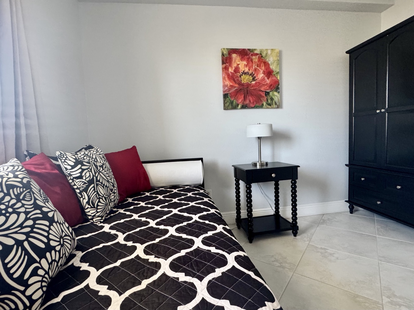 Sink into comfort on your cozy twin bed with plush pillows, perfect for afternoon reading or relaxing after exploring the area.