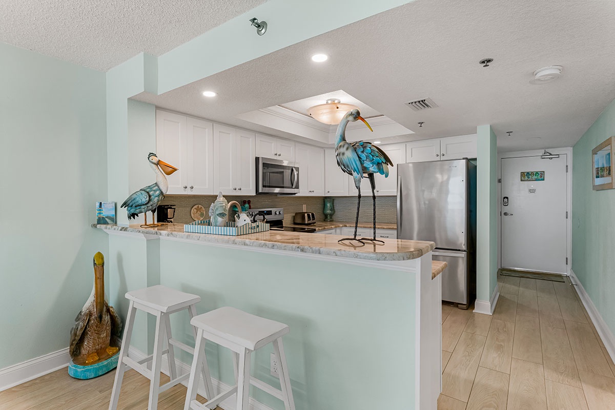 Your coastal-themed kitchen features granite counters, stainless appliances, and charming nautical decor that makes cooking feel like a seaside adventure.