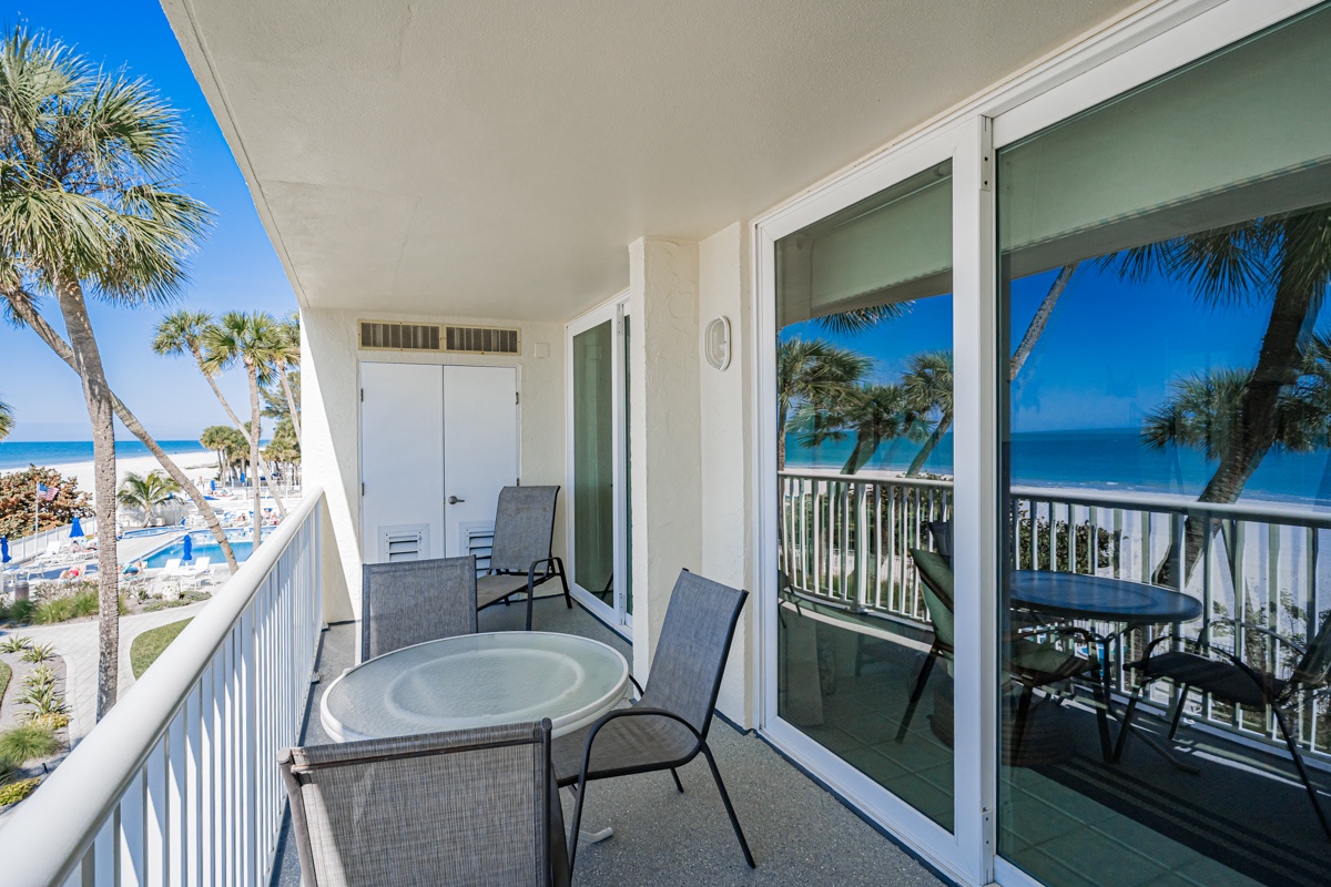 Your private balcony frames stunning ocean views through swaying palms. Enjoy morning coffee or evening cocktails at the table while breathing in the salty breeze.