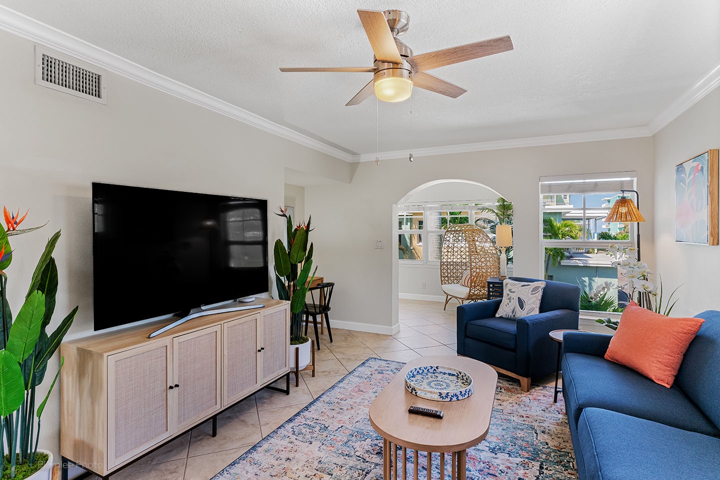 Living area, large smart TV, ceiling fan, view to Gulf