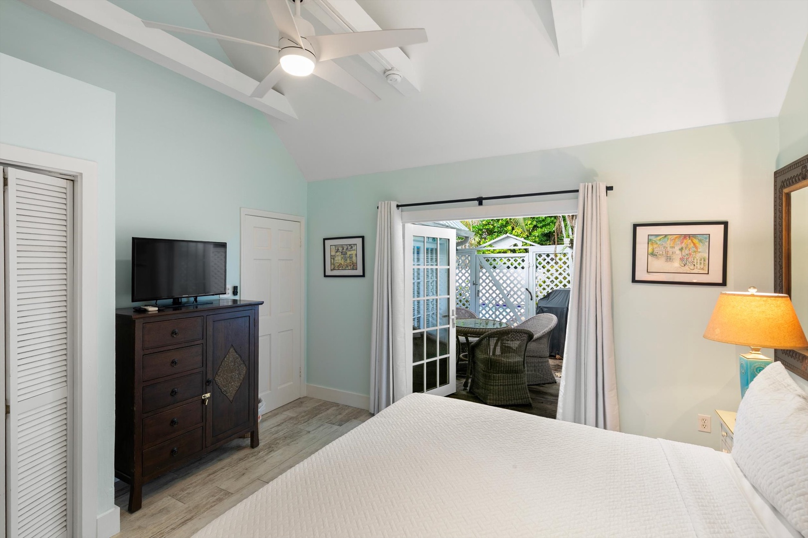 Relax in your peaceful bedroom with soothing coastal colors, soaring vaulted ceilings, and direct access to your private outdoor patio—perfect for morning coffee.