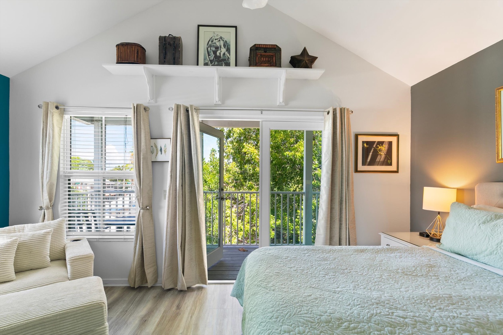 Step into your bright, peaceful bedroom where natural light pours through glass doors opening onto a private balcony. Sink into crisp linens and let the leafy views soothe you after a full day.