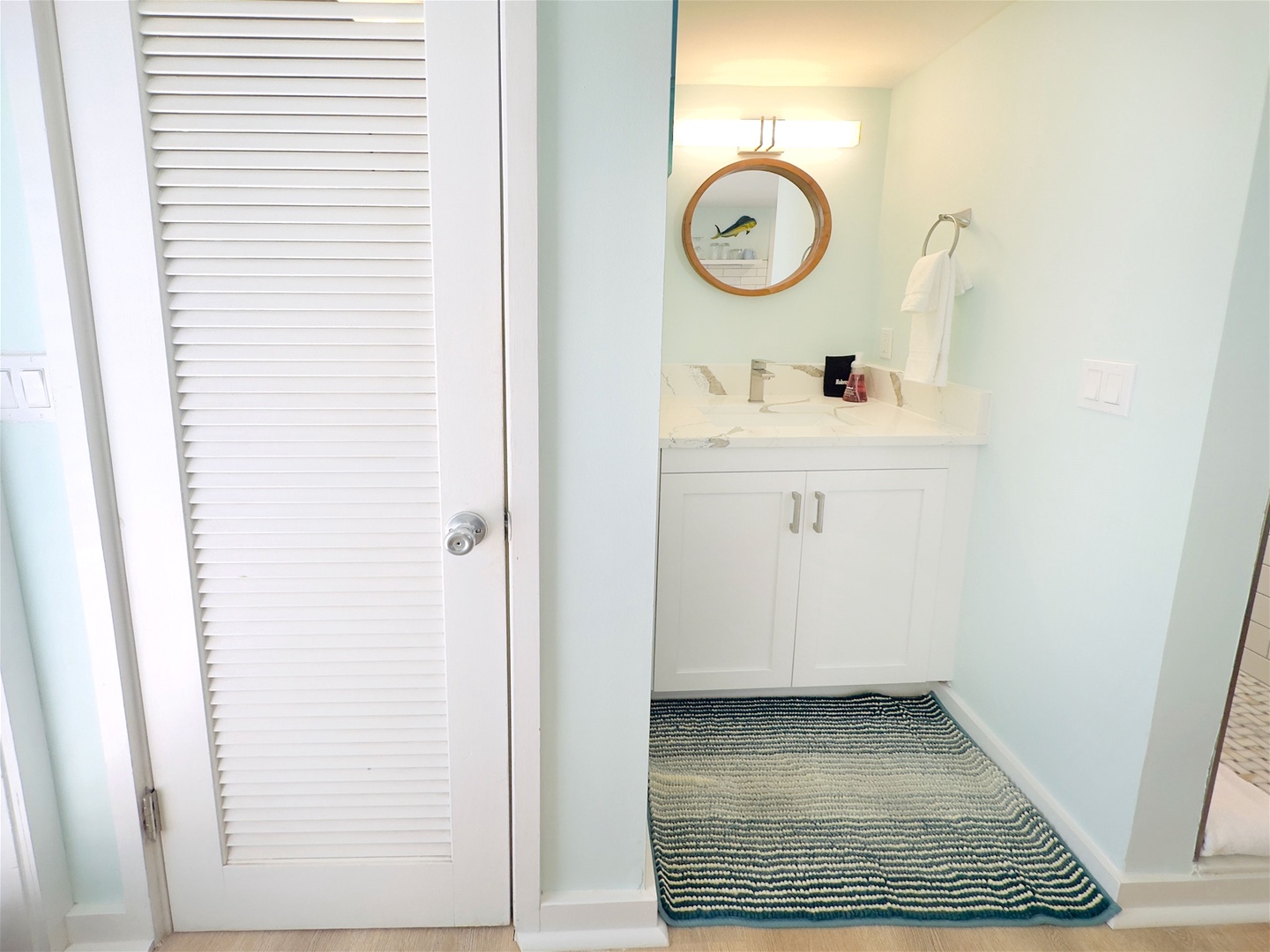 Enclosed toilet area next to vanity