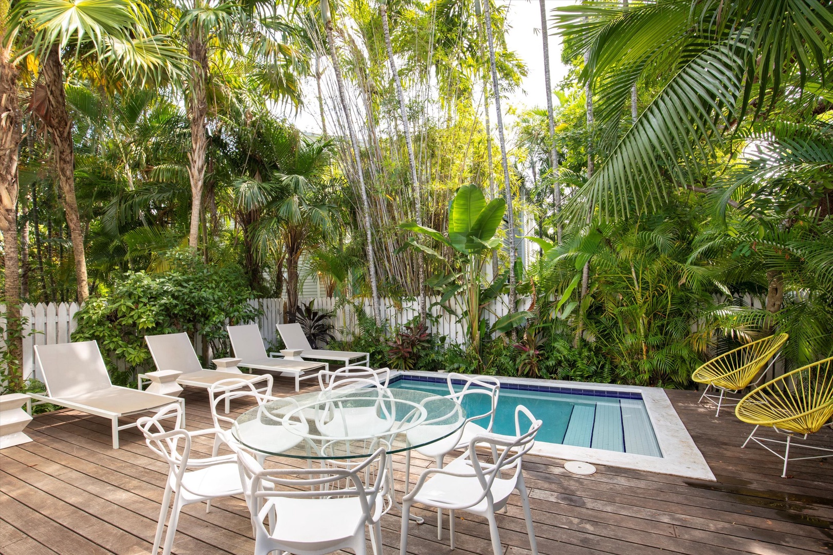 Pool deck with lounge chairs and outside dining area