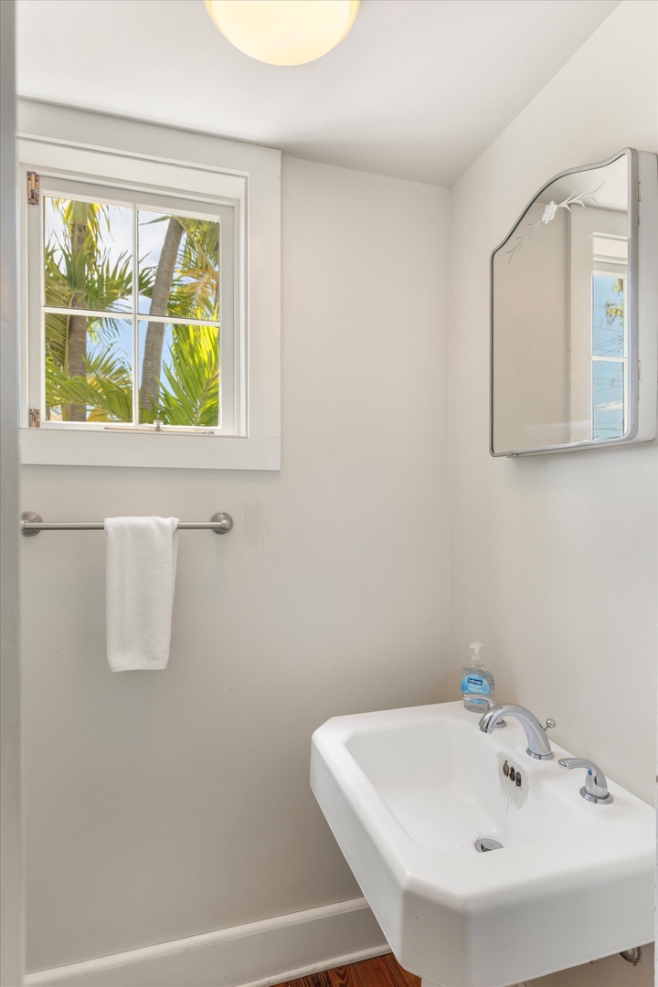 Clean, bright bathroom with tropical palm views—your refreshing retreat after beach days and adventures.