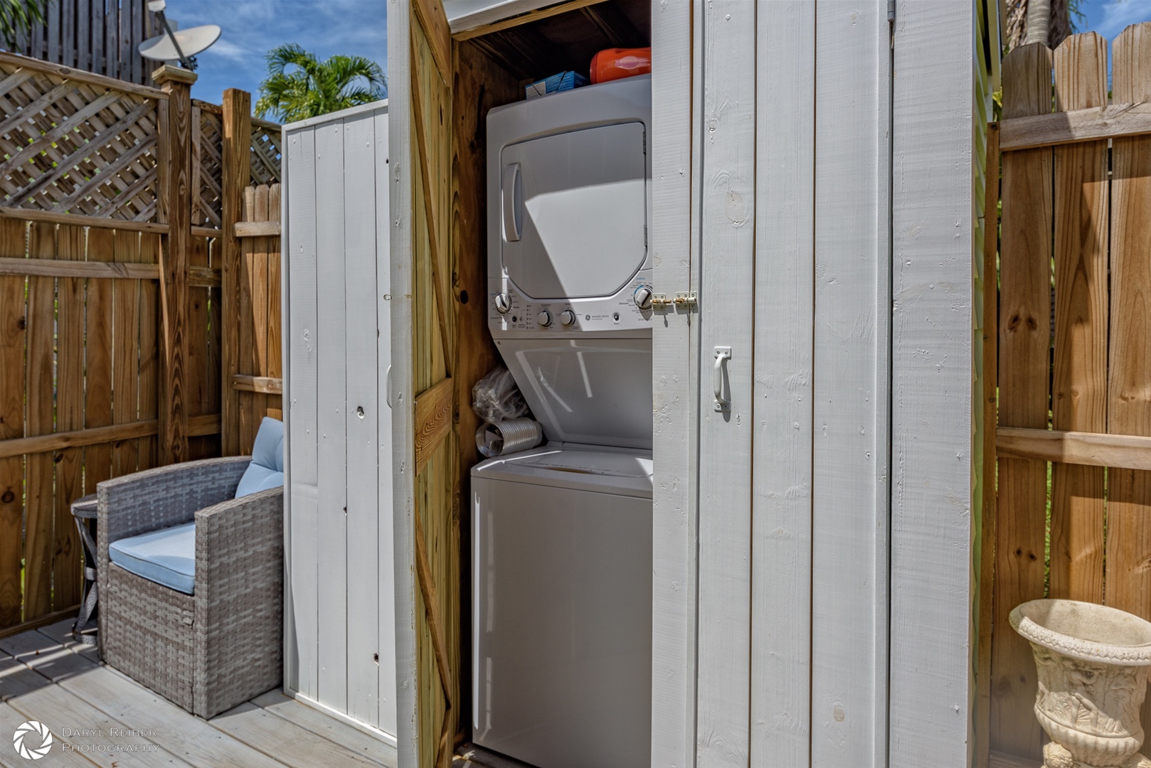 outdoor laundry area with stackable washer and dryer