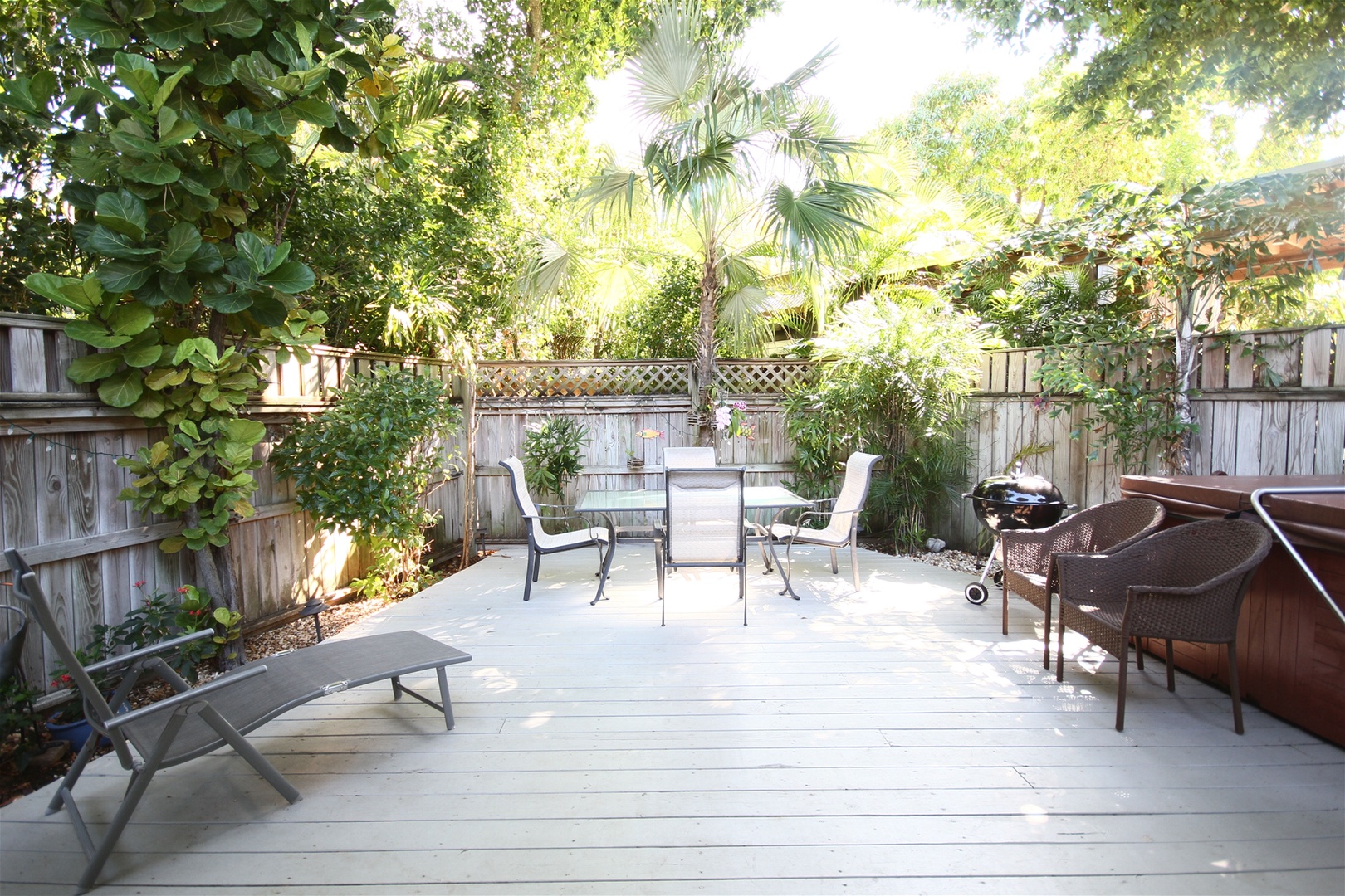 Fenced in back yard with deck and seating area