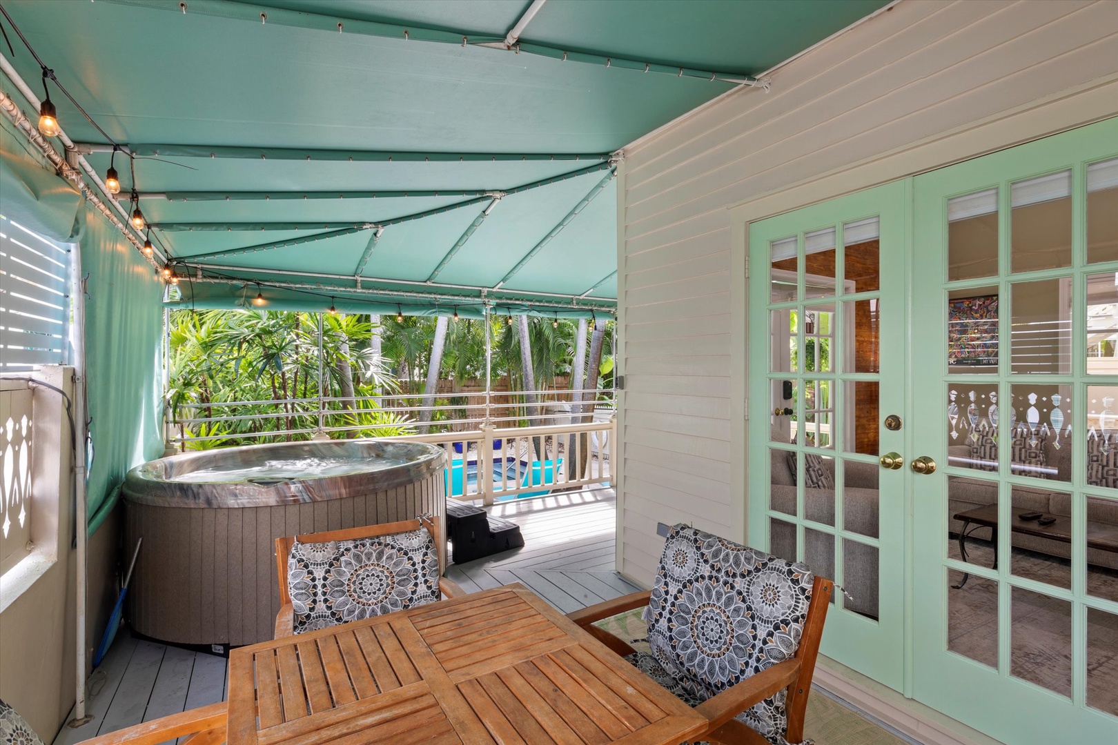 Private hot tub on wrap around porch and outdoor seating / 2nd french door entry