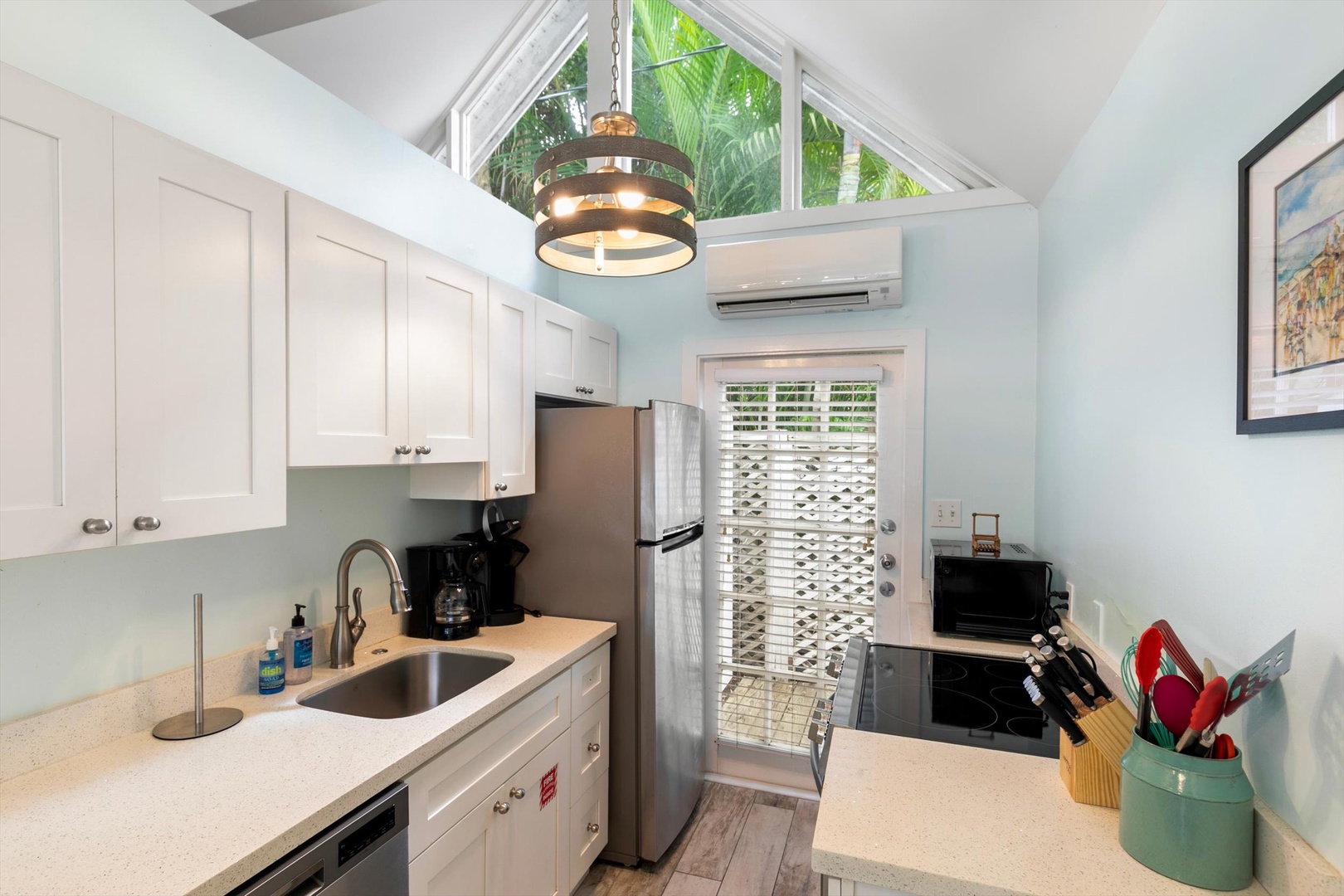 Your bright, fully equipped kitchen offers everything you need to whip up your favorite meals. Sunlight pours in through the skylight, and tropical greenery peeks through the windows, creating a cheerful place to cook and gather.