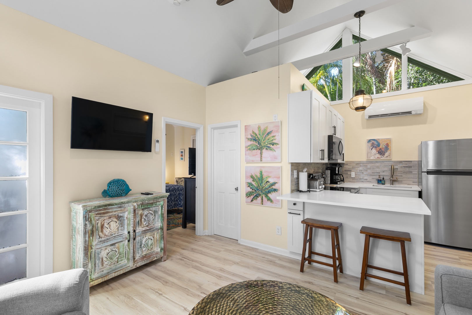 Bright, open-concept space where you can relax under vaulted ceilings and soak in tropical garden views through skylights above your fully-equipped kitchen.