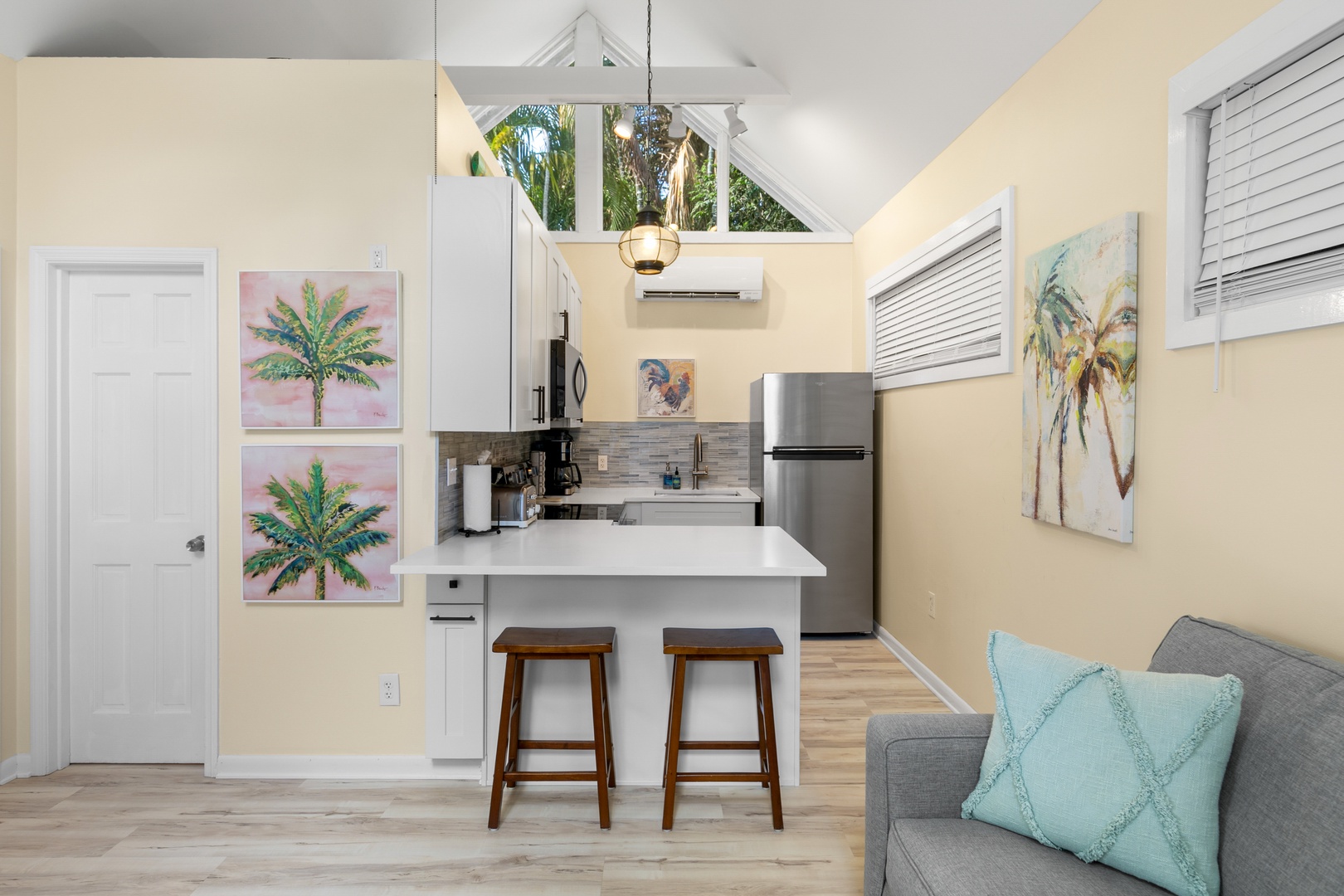 Your bright, airy retreat blends coastal charm with modern comfort—cathedral ceilings, sleek kitchen with breakfast bar, and a cozy living area perfect for unwinding after sun-soaked adventures.