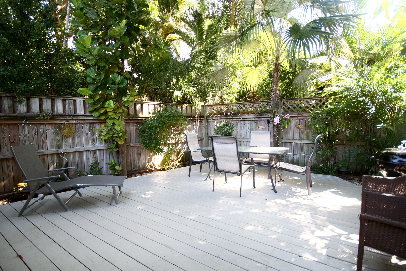 Fenced in back yard with deck and seating area
