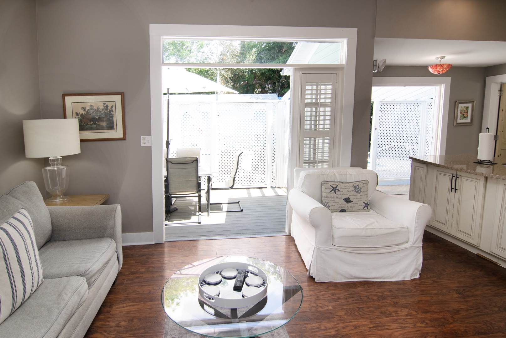 Living Room with french doors that open up to a private deck with seating