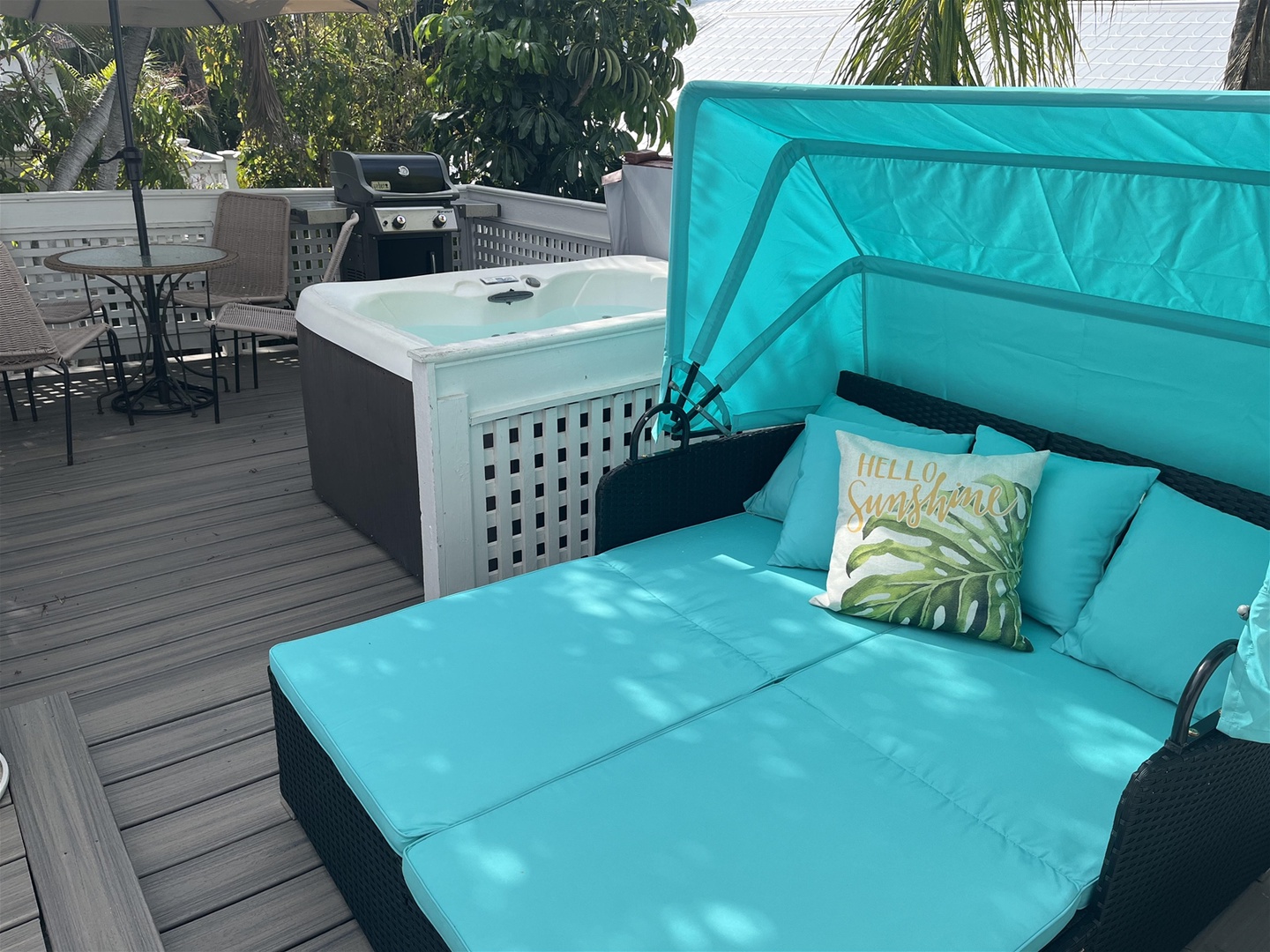 Private rooftop deck with couch lounger, hot tub, gas grill and sitting area