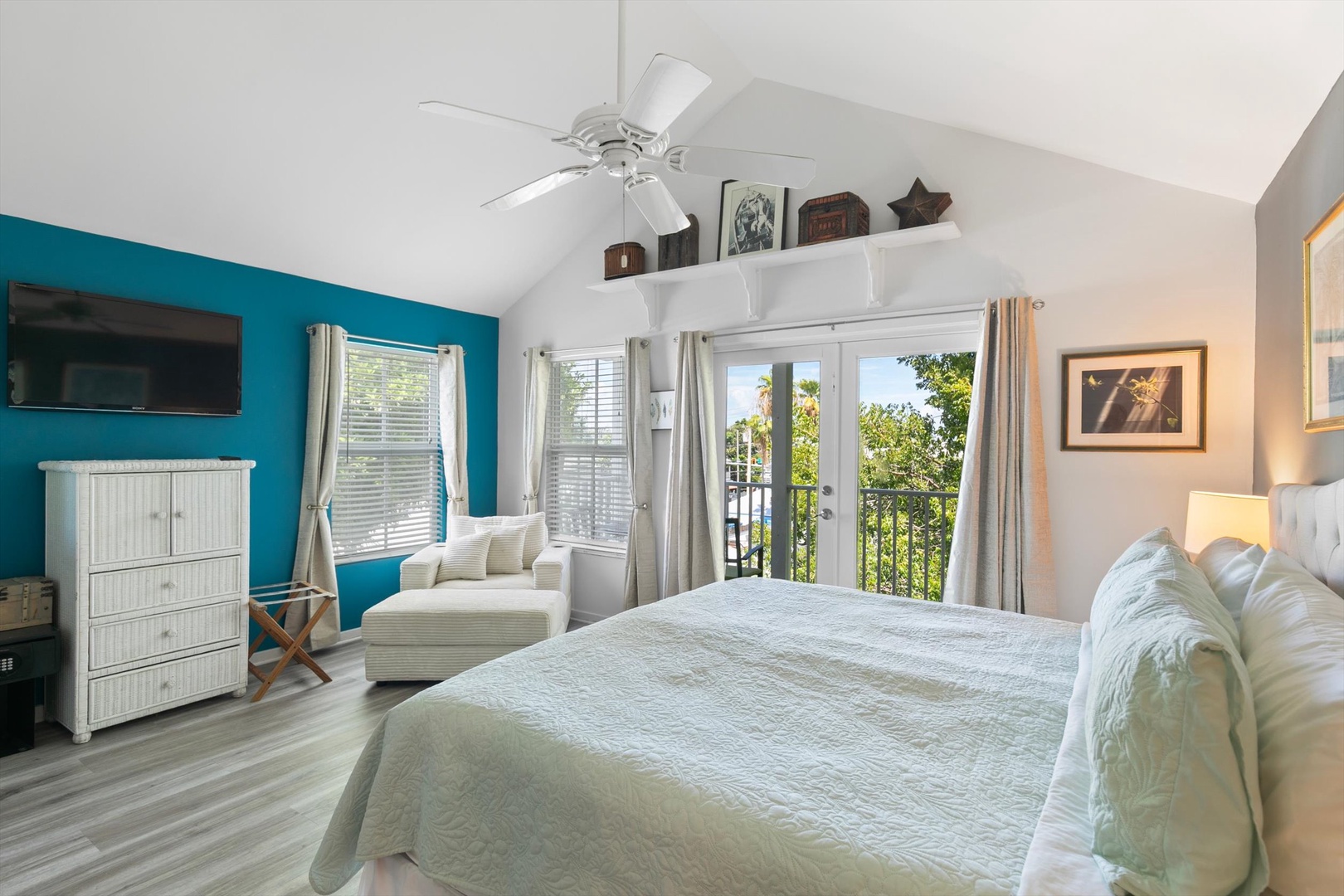 Wake up to natural light streaming through French doors that open to your own private space. The vaulted ceiling and coastal palette invite you to relax and unwind in breezy comfort.