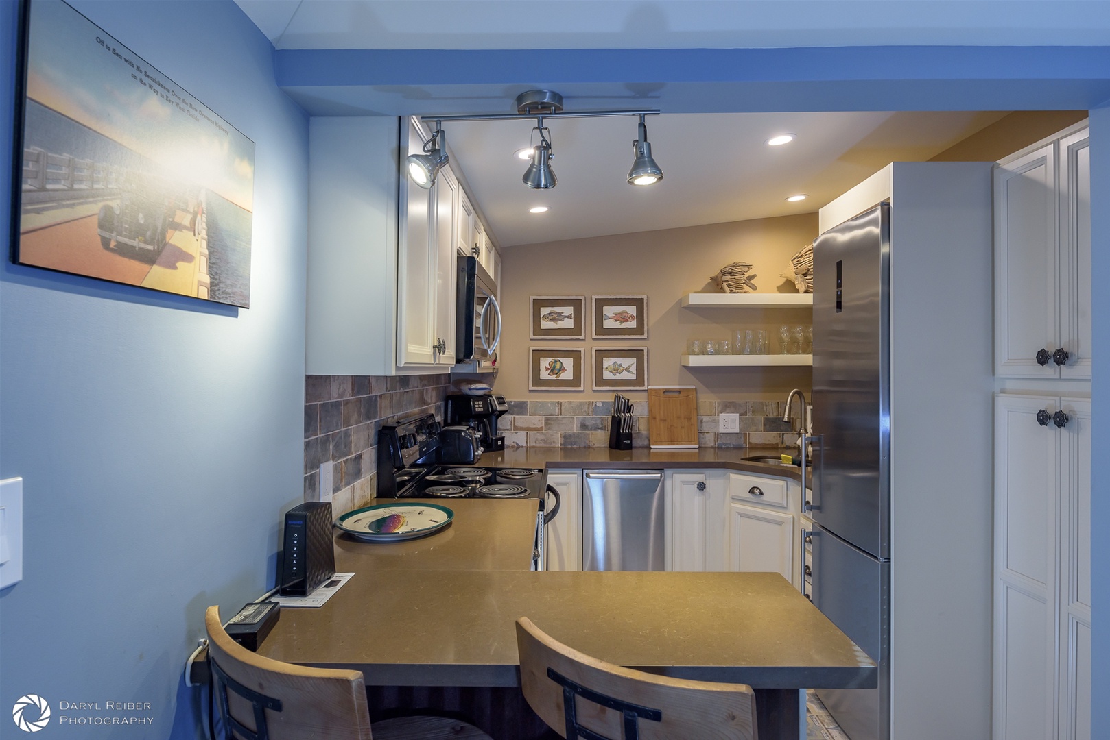 Breakfast bar and view of full kitchen