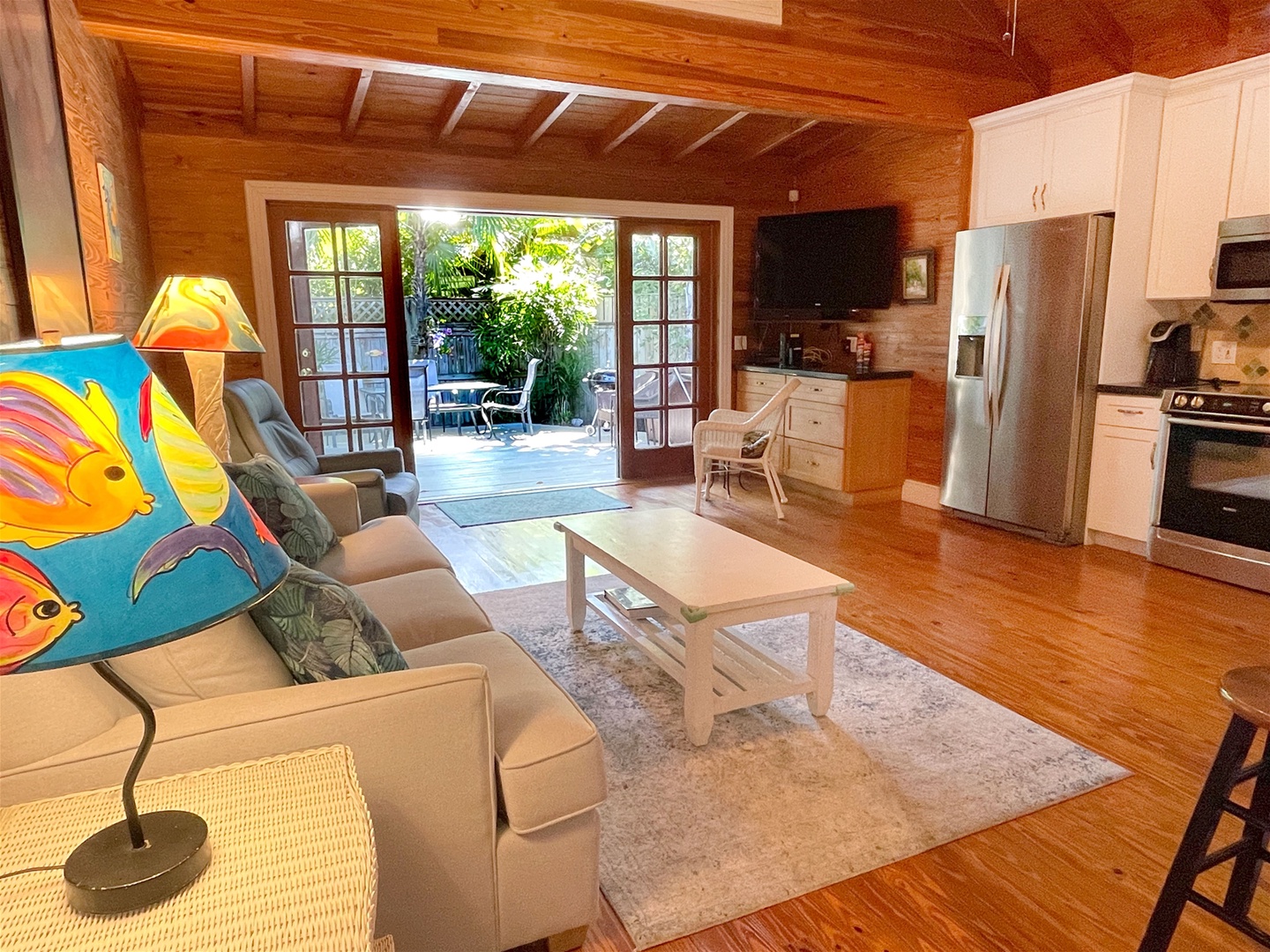 Full view open concept layout with french doors that open up to private deck with seating