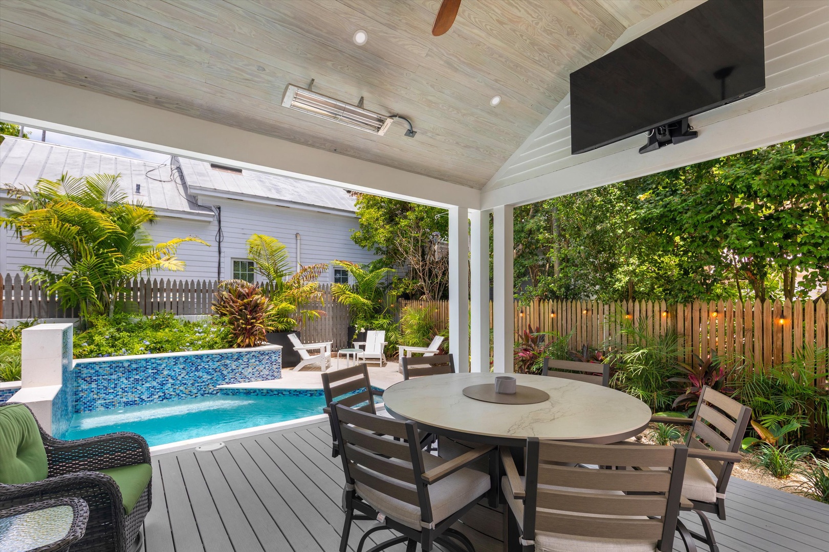 Picture yourself enjoying morning coffee at your private covered patio, overlooking the sparkling pool surrounded by lush tropical greenery and complete privacy.