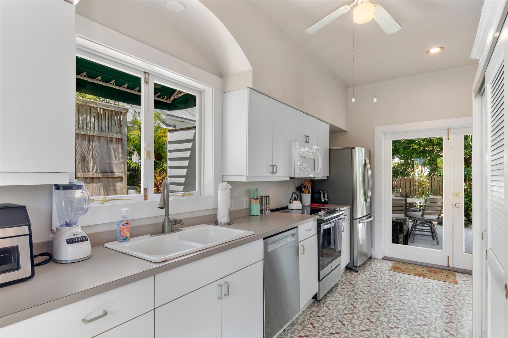 Your bright, fully equipped kitchen invites you to whip up meals with modern appliances and opens effortlessly to the backyard patio for easy indoor-outdoor living.