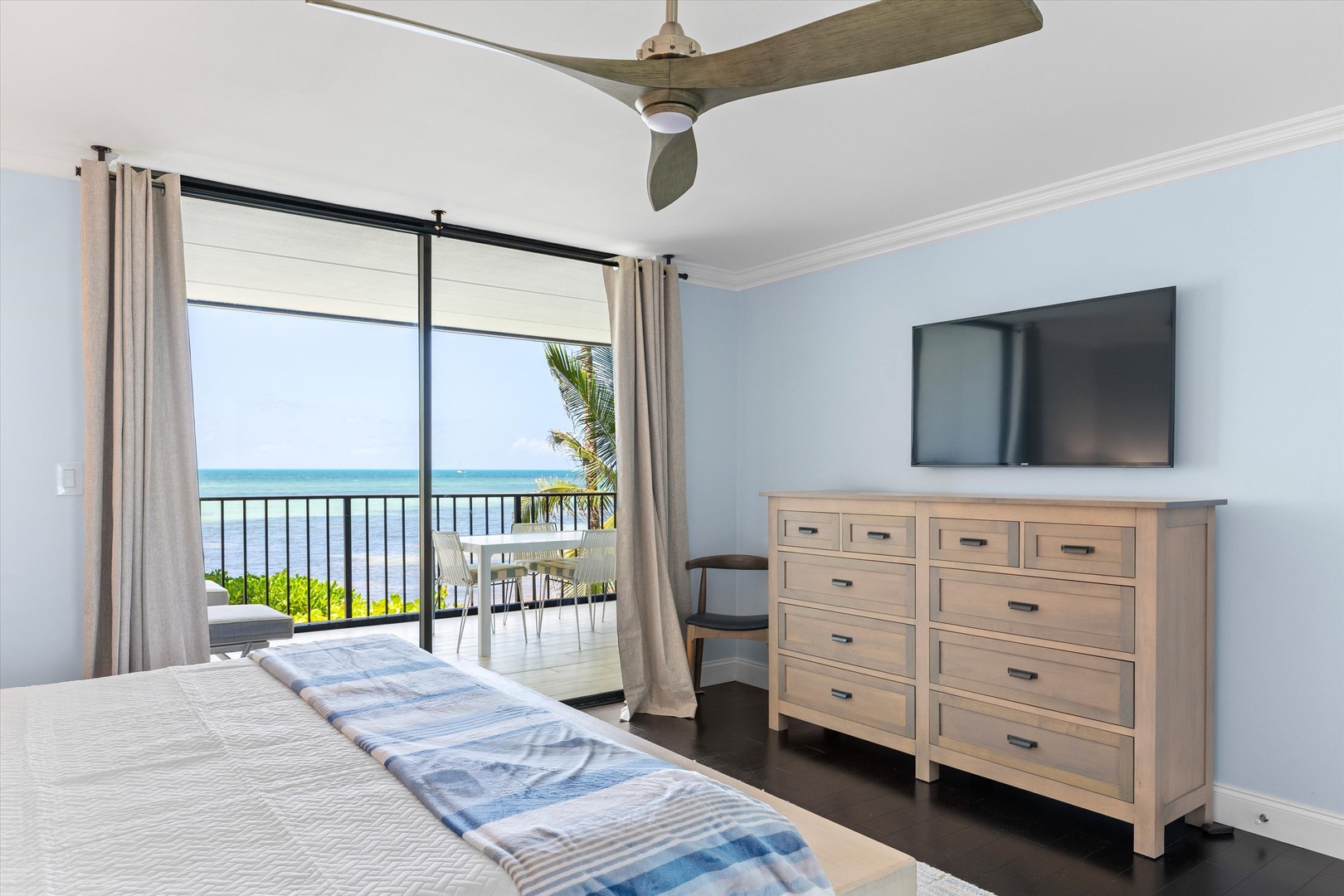 Primary bedroom with walk out balcony and seating