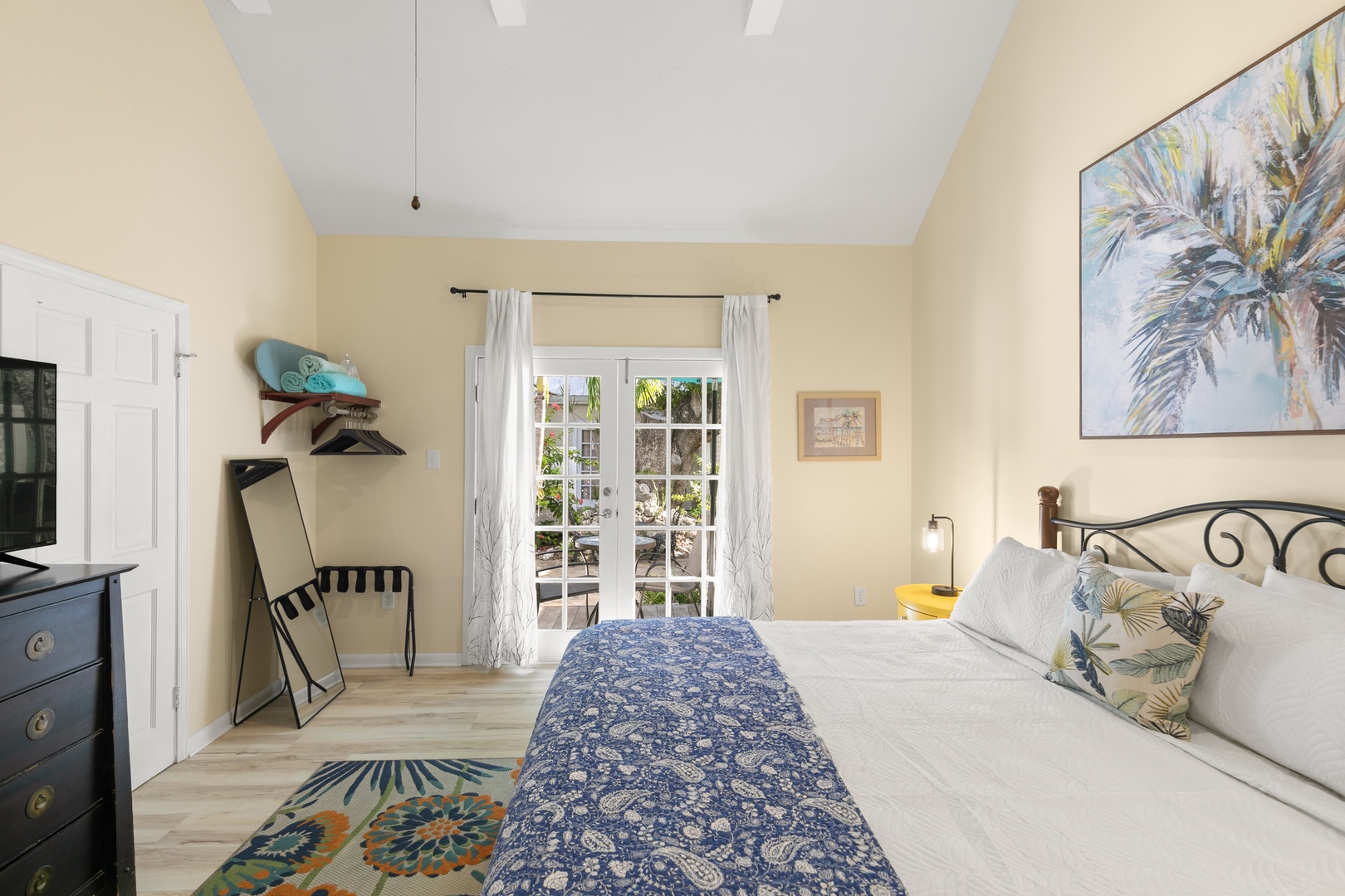 Step into your serene coastal retreat, where soft morning light spills through French doors and touches of blue and tropical accents create the perfect escape for relaxation.
