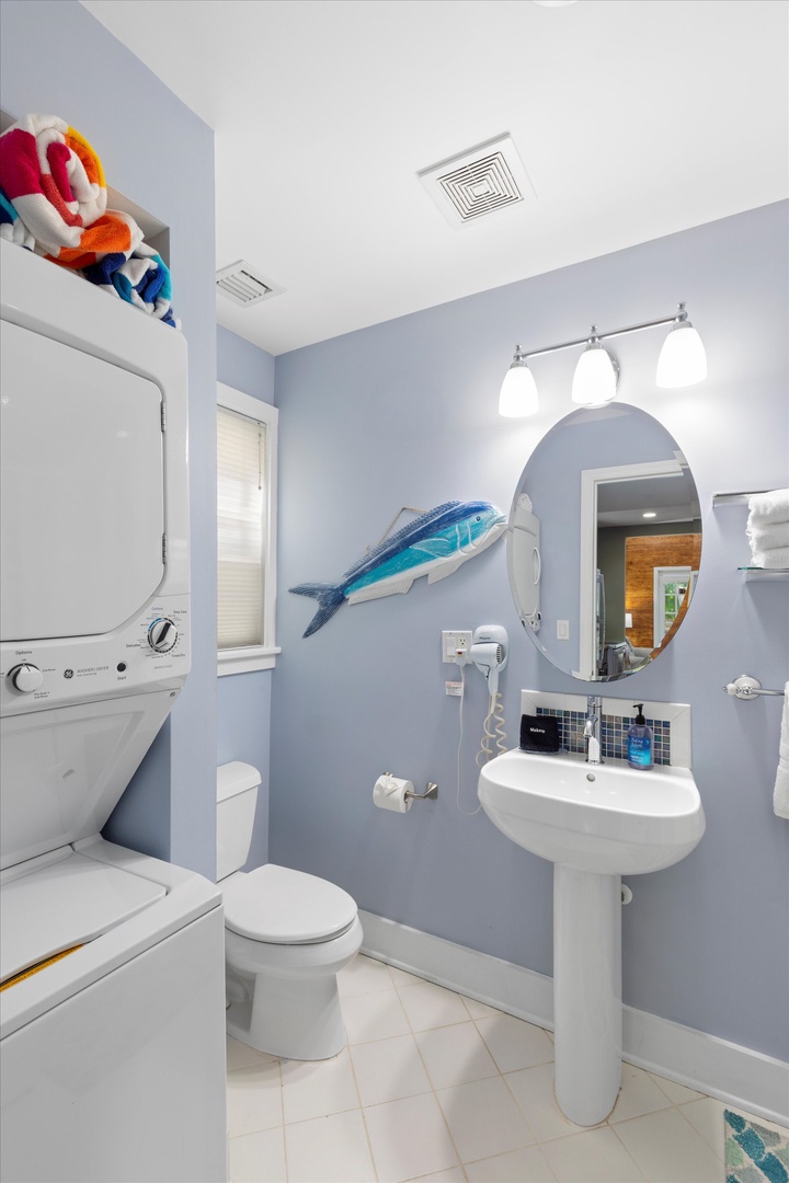Full bathroom with washer and dryer