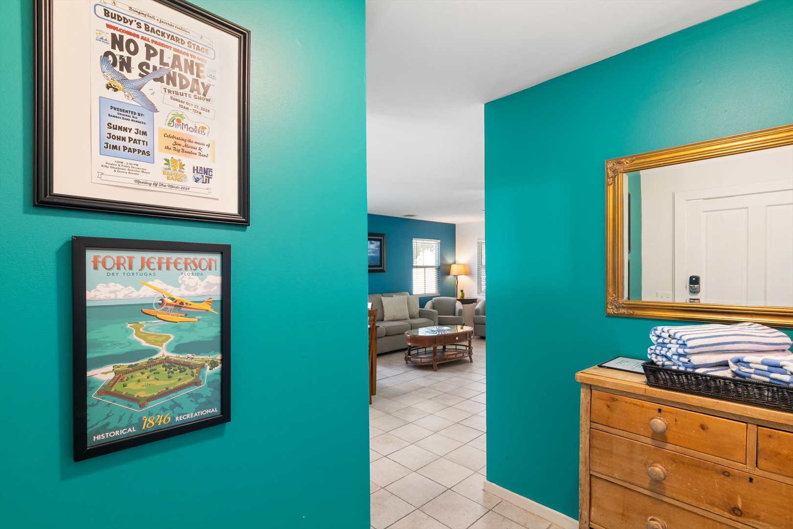 Step into a cheerful hallway with vibrant turquoise walls and coastal-inspired decor that welcomes you to your home away from home.