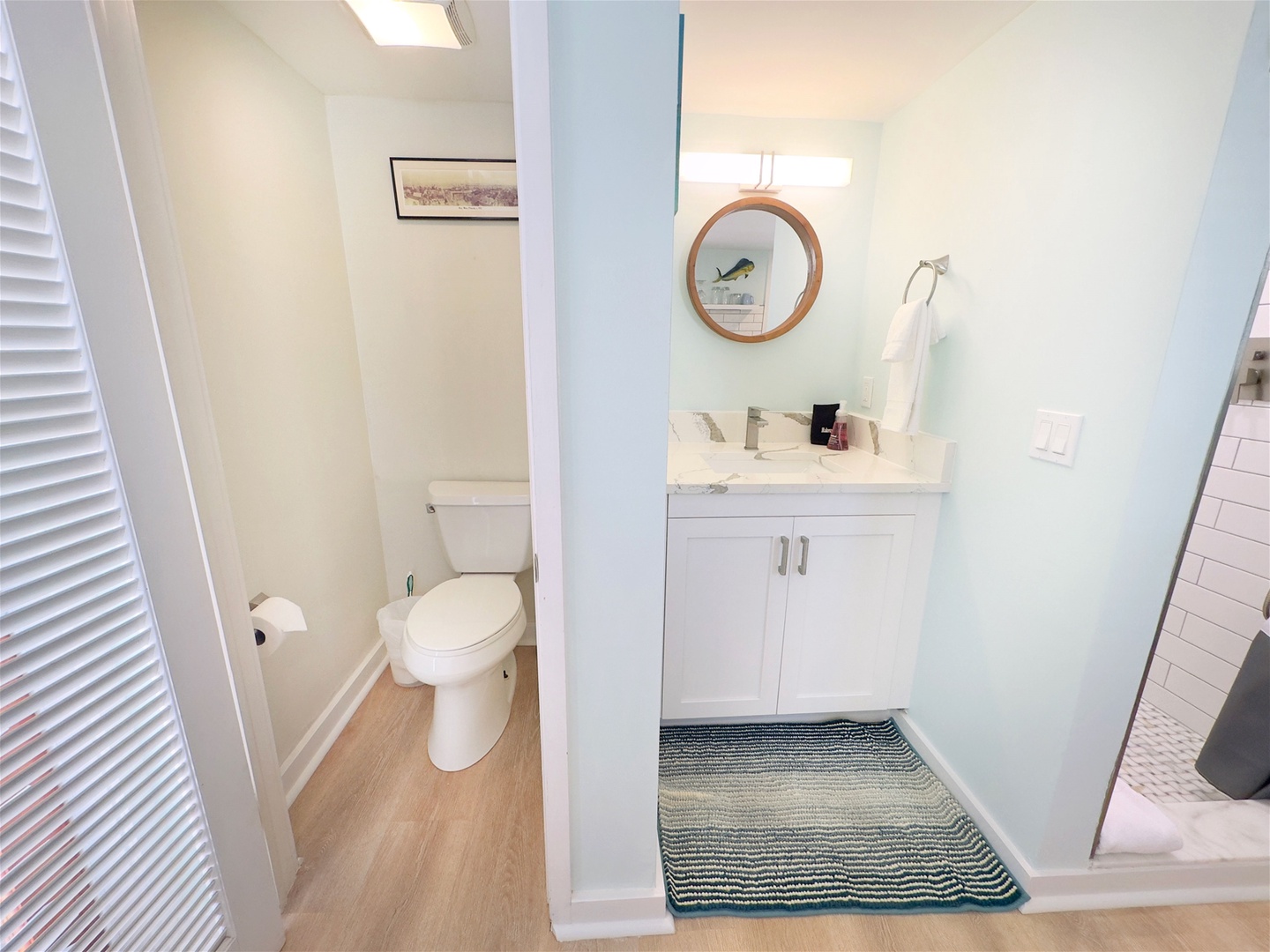 Enclosed toilet area next to vanity