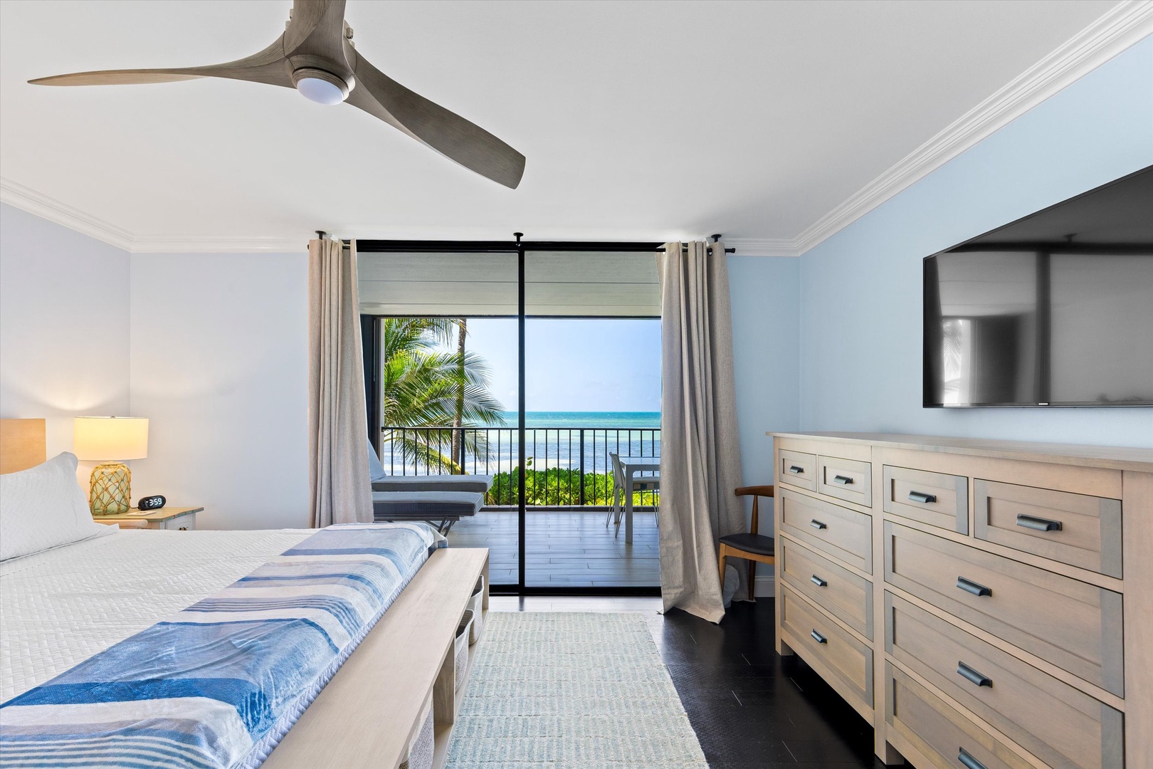 Primary bedroom with walk out balcony and seating