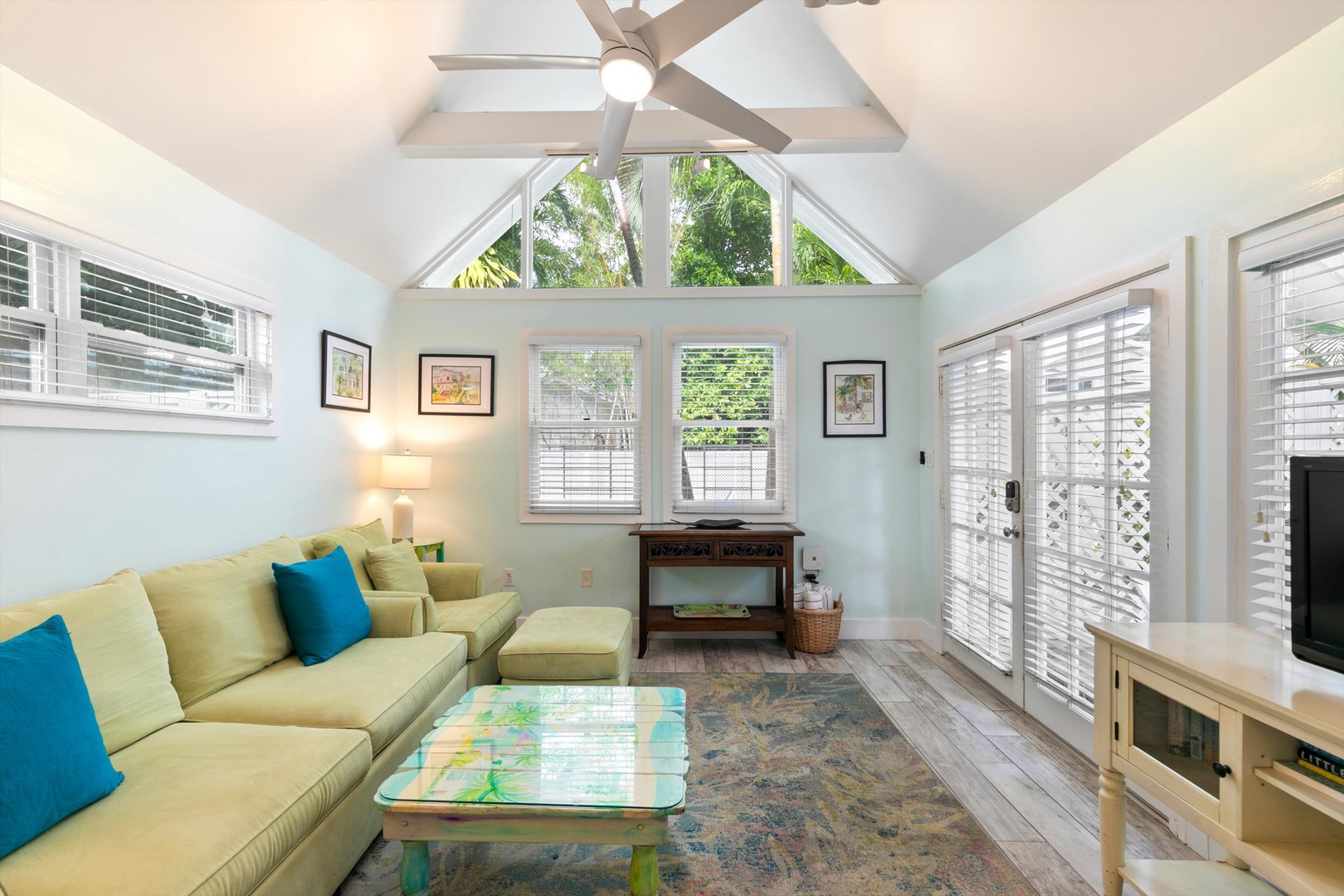 Settle into your bright, airy living room where vaulted ceilings and tropical garden views create a breezy, welcoming retreat.