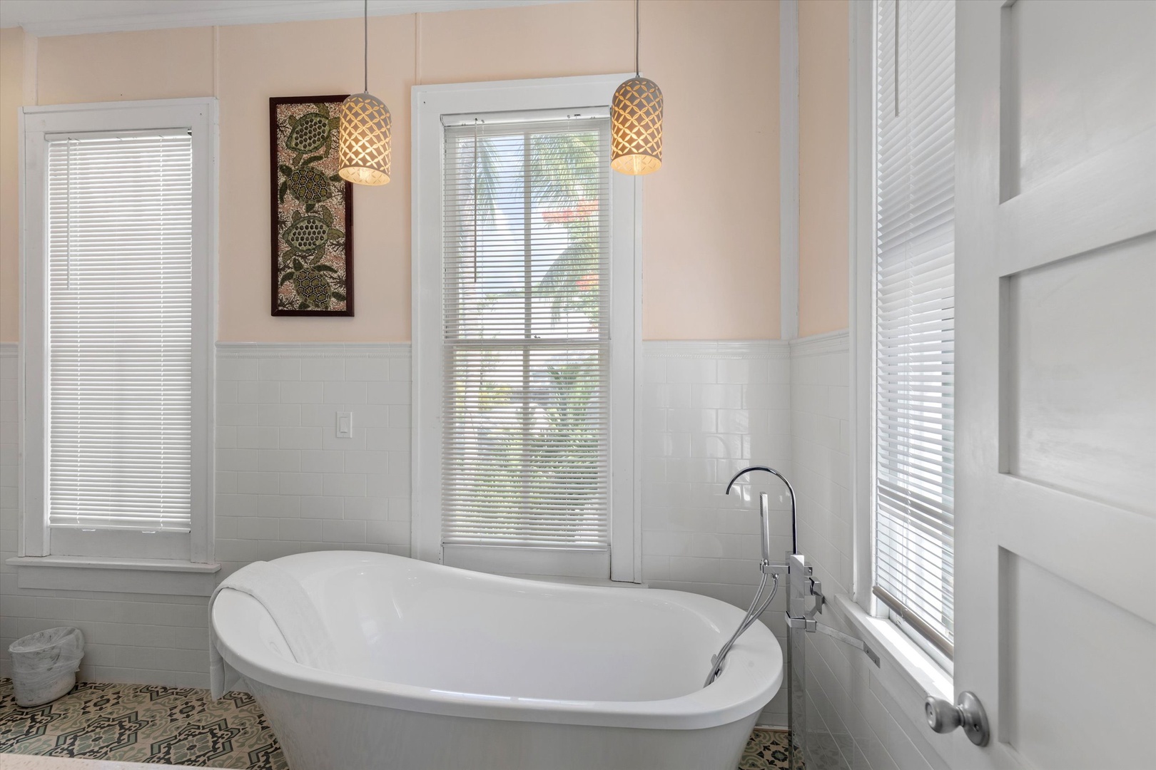 Sink into the elegant soaking tub and let soft light filter through. This serene bathroom blends modern style with soothing ambiance, perfect for unwinding after your adventures.