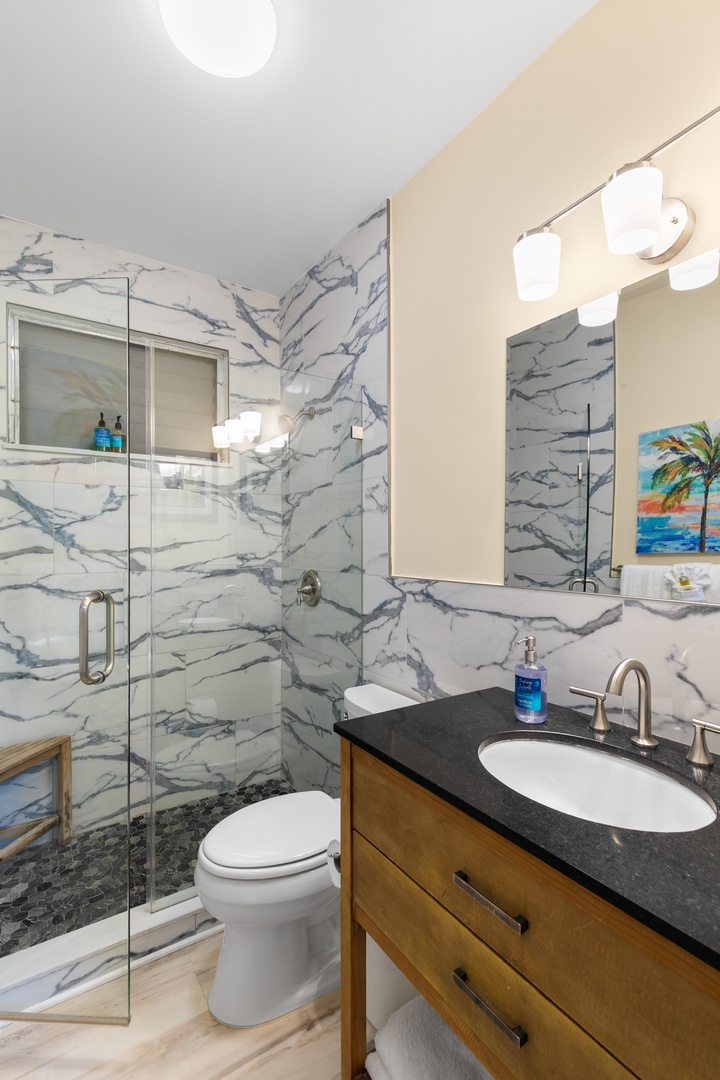 Refresh in your sleek marble bathroom with a spacious walk-in shower and modern vanity—perfectly styled for a relaxing escape.