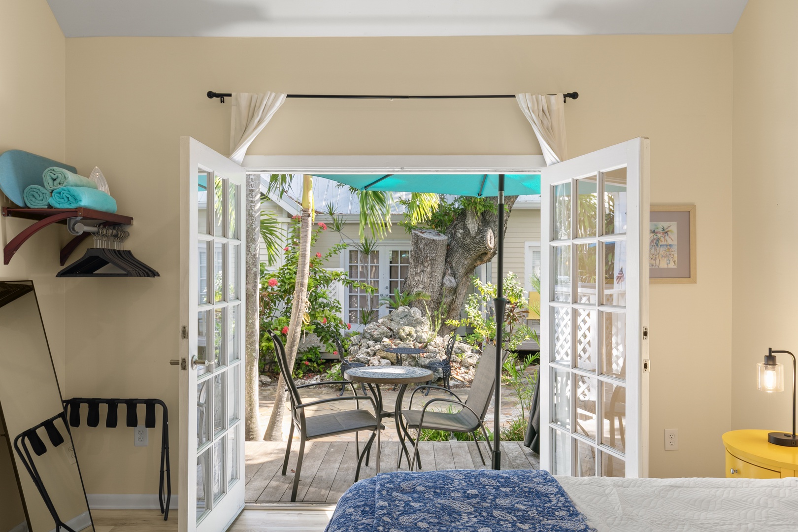 Open the French doors to your own private garden retreat, where tropical palms and native plantings surround a quiet table for two—perfect for morning coffee or evening relaxation.