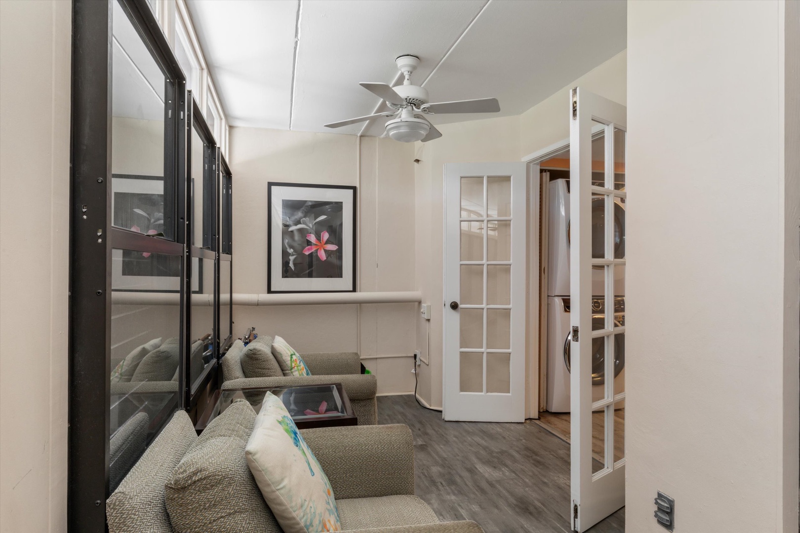 Front entry seating area with doors into kitchen/laundry area