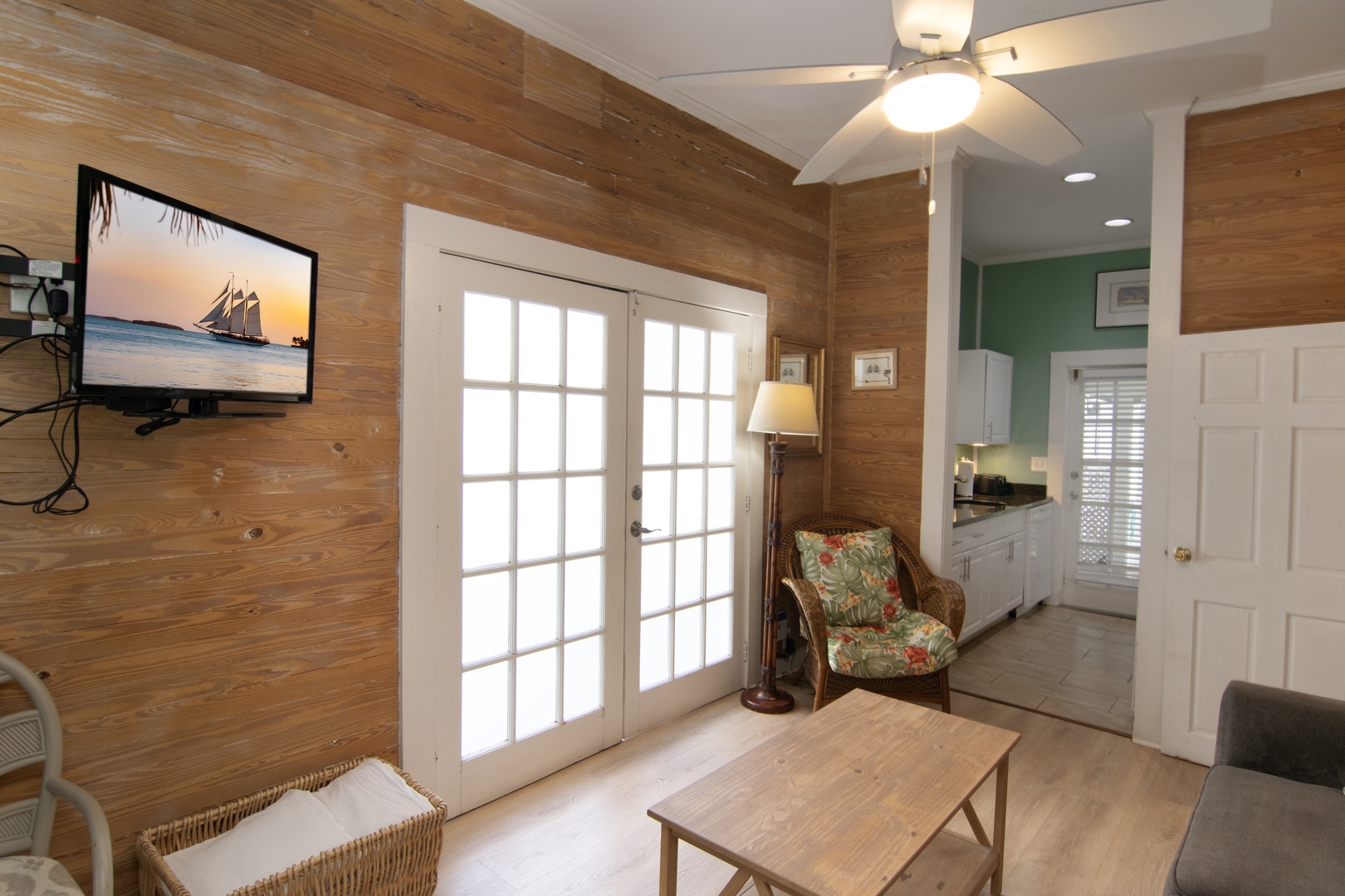 French doors in living room that open up to a garden courtyard with easy access to shared pool