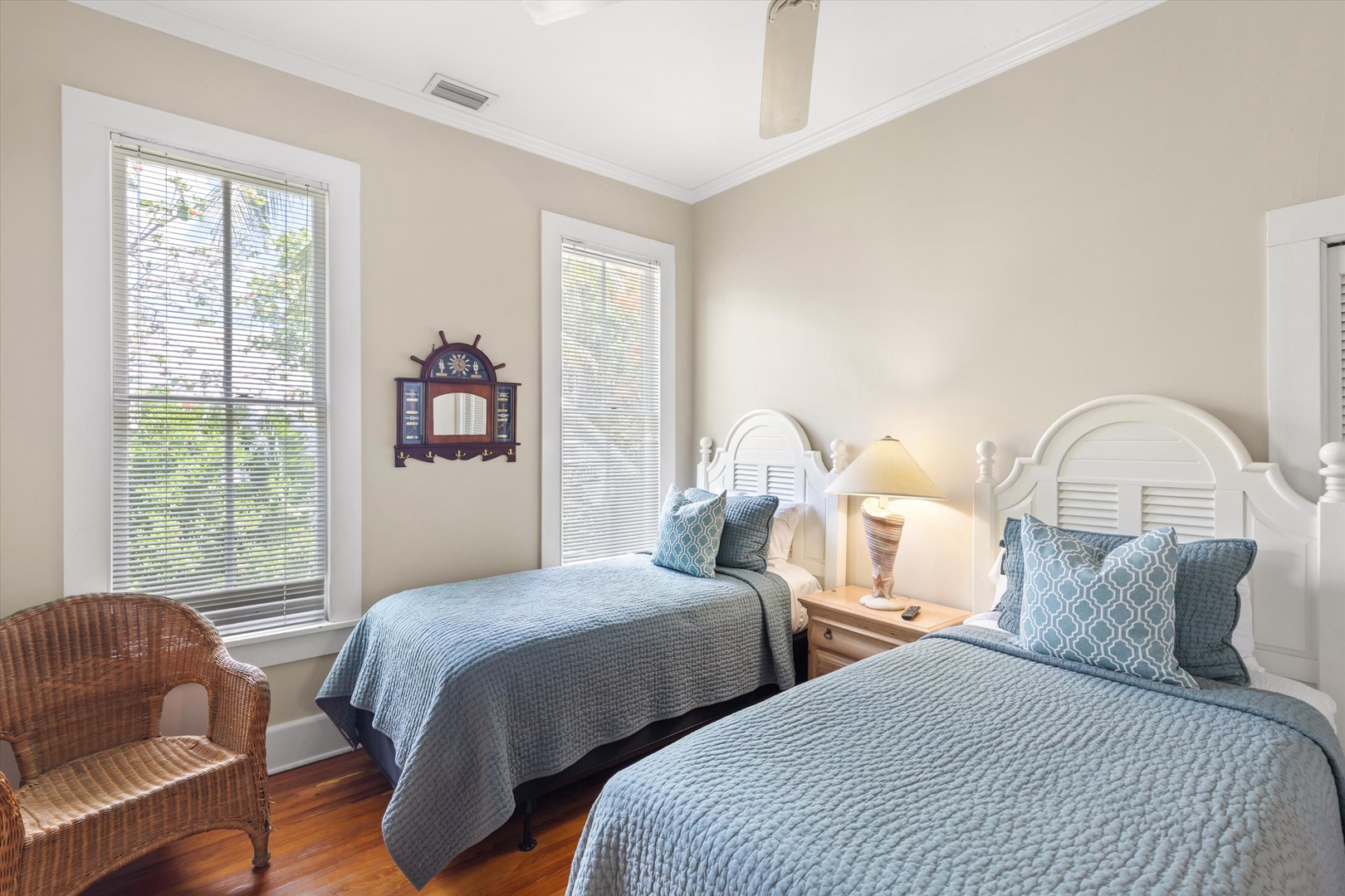 Settle into your comfortable twin bedroom, styled with coastal charm and soft blue linens. Natural light floods through large windows, creating a peaceful retreat after days exploring.