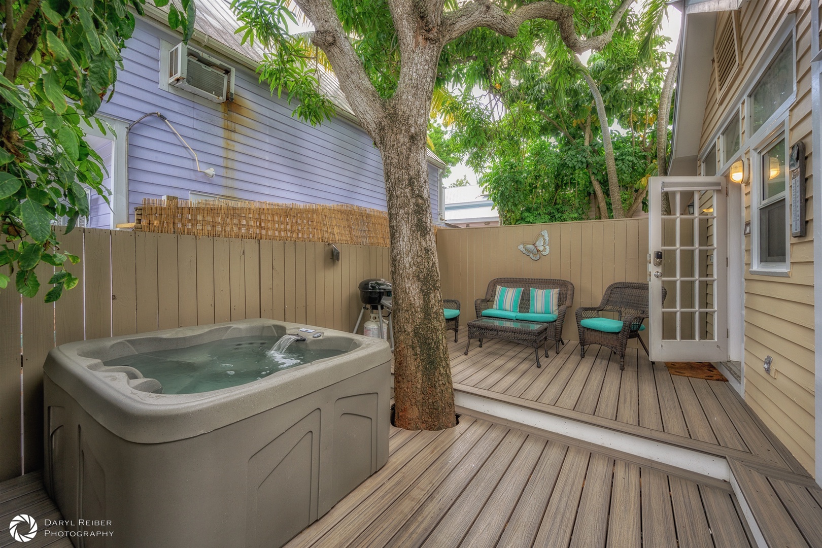 Private deck with hot tub and seating area and grill