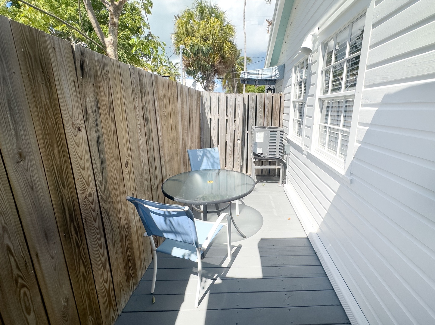 door off kitchen leads to small deck with seating