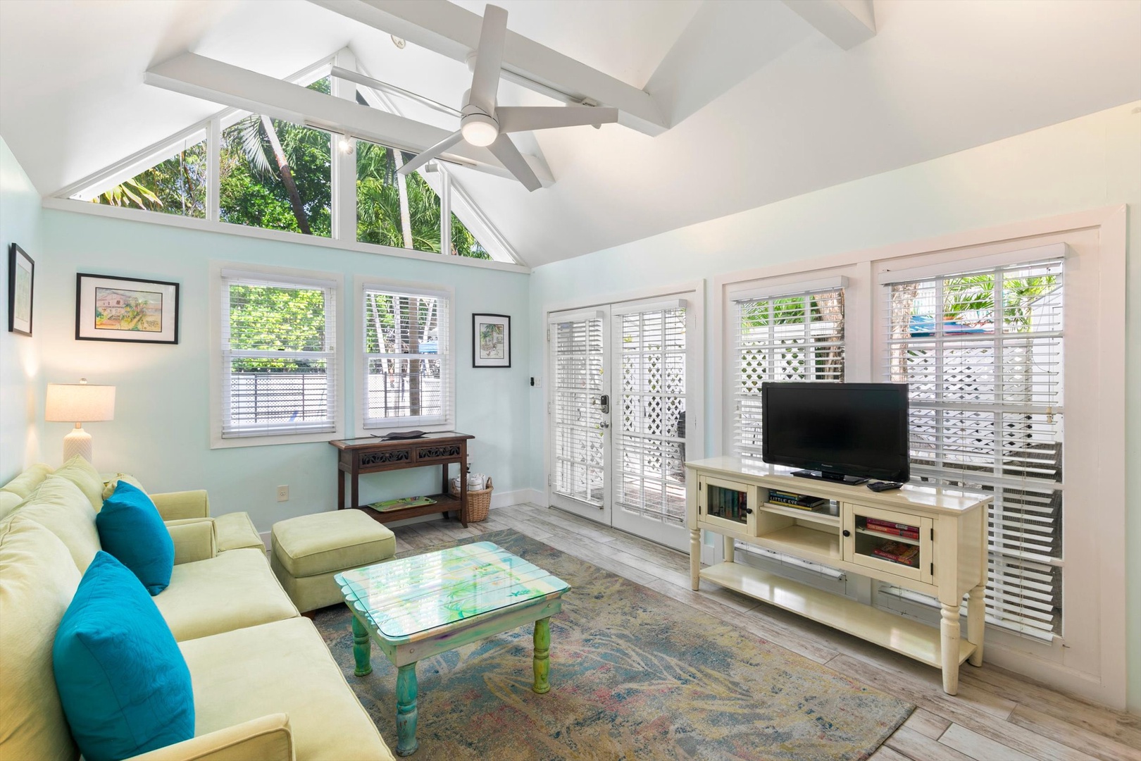 Relax in your bright and airy living room with soaring vaulted ceilings and tropical garden views. The space opens to a private patio, perfect for your morning coffee or evening unwind.