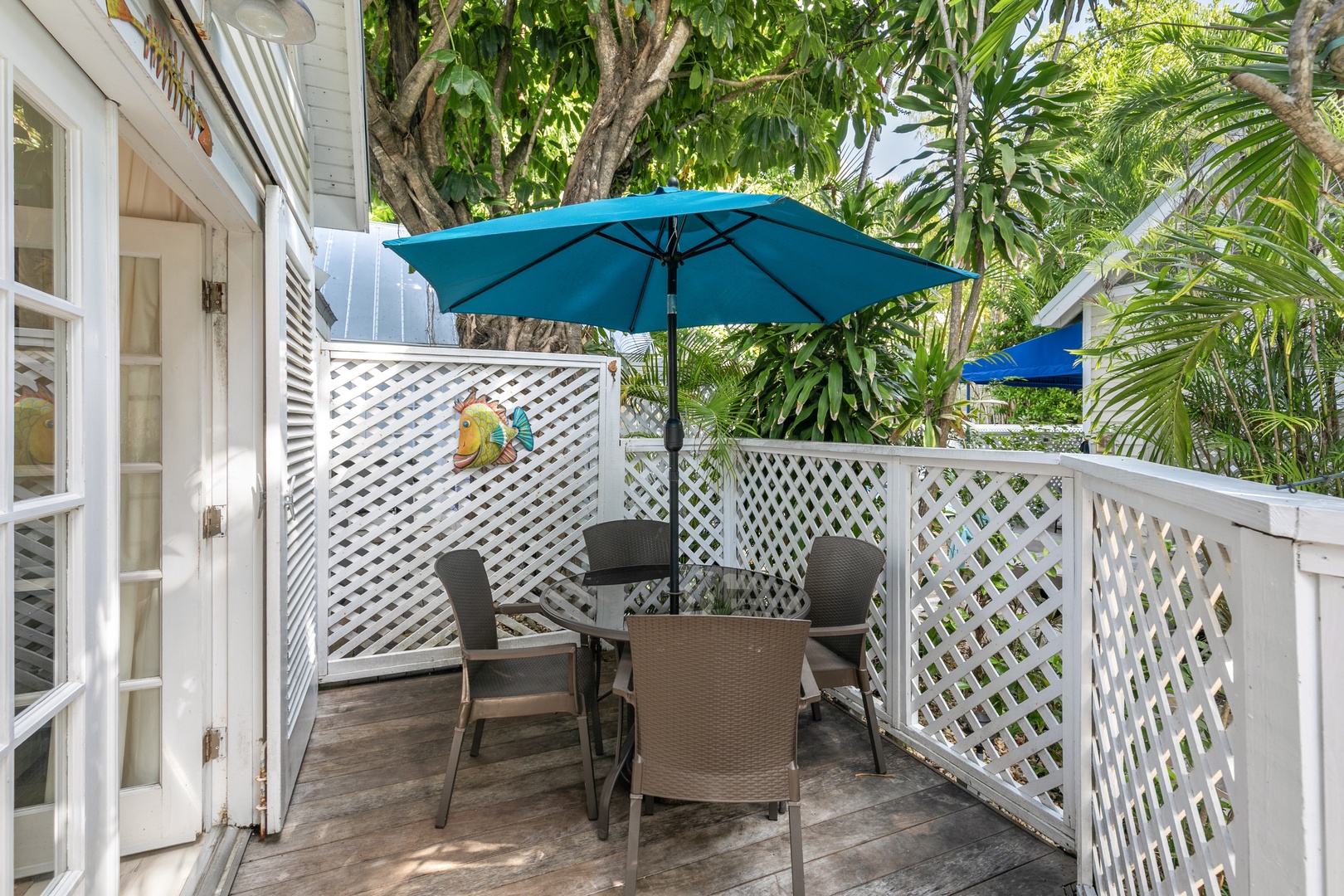 Your own private oasis awaits on this charming deck, where morning coffee or sunset cocktails feel like a mini escape beneath swaying palms and vibrant tropical greenery.