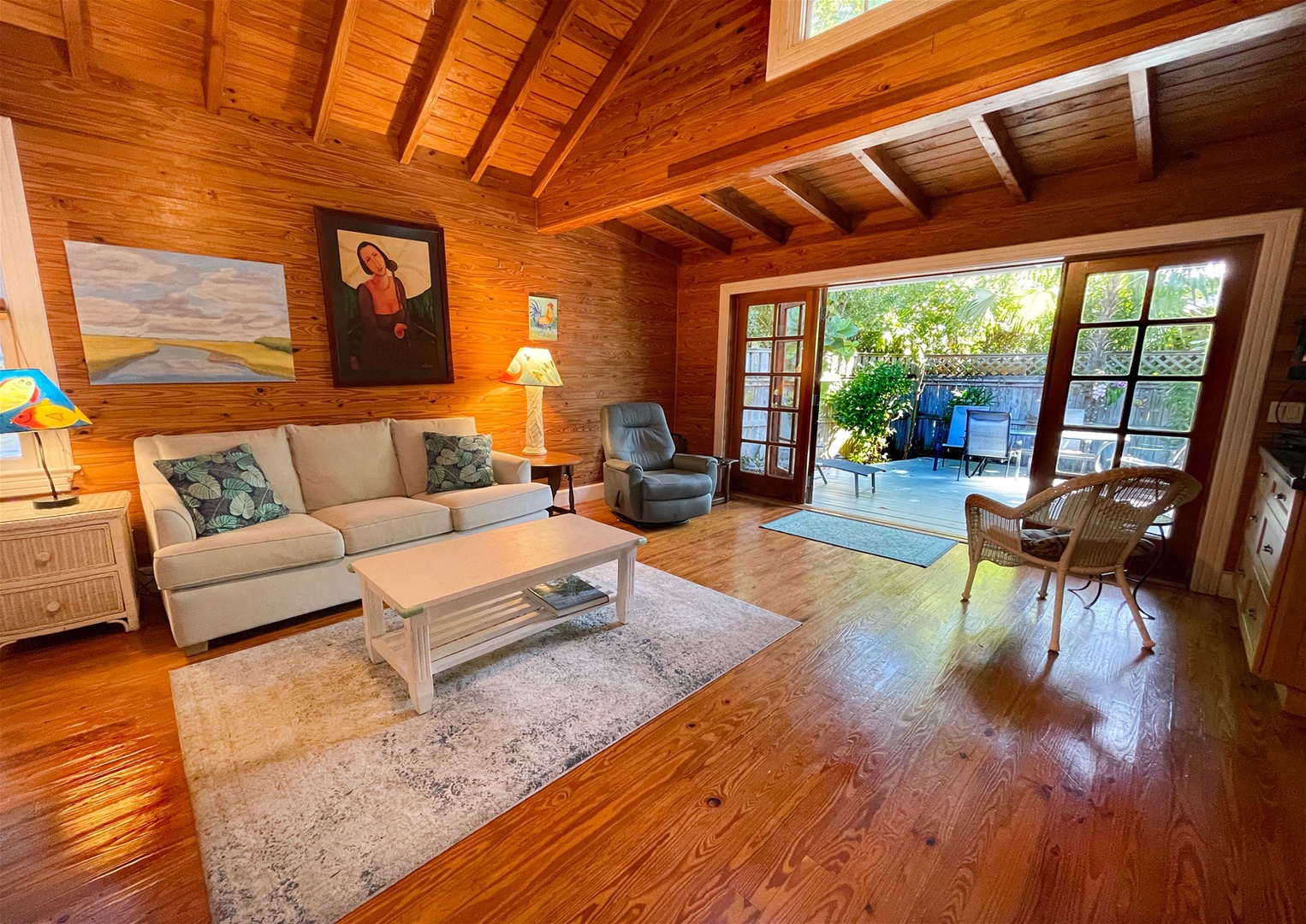 Full view open concept layout with french doors that open up to private deck with seating