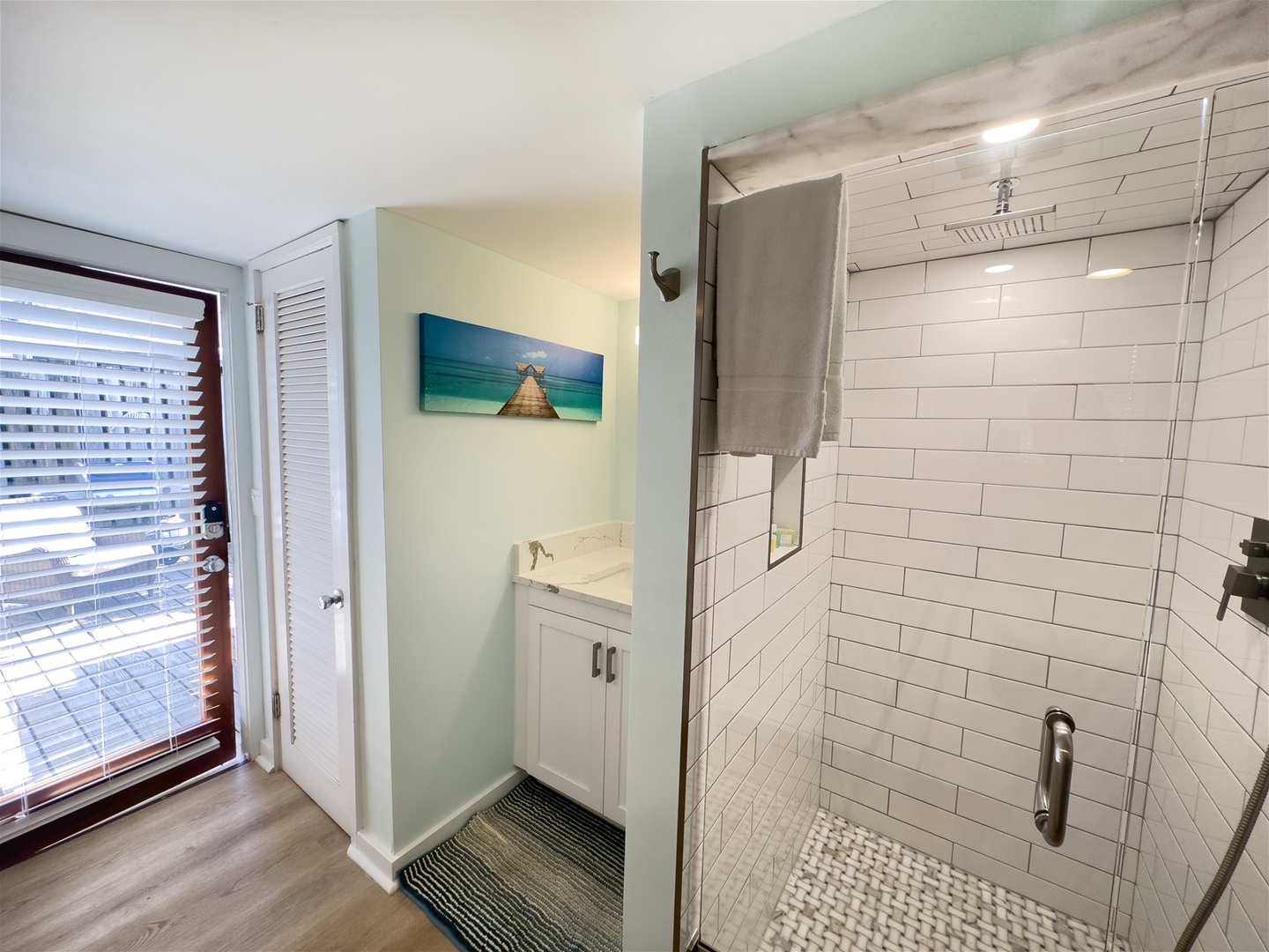 Enclosed toilet area next to vanity and shower