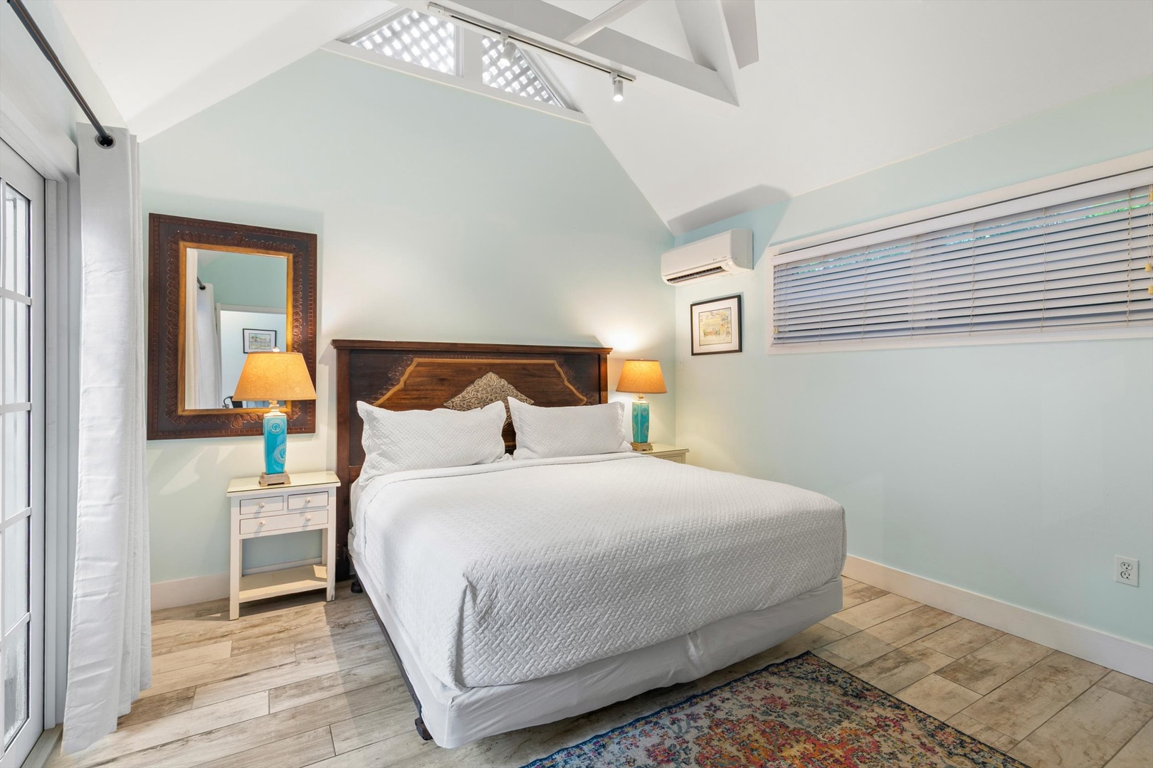 Unwind in your peaceful bedroom, where vaulted ceilings and soft coastal hues create a soothing retreat. Crisp linens and warm bedside lighting invite restful nights after your island adventures.