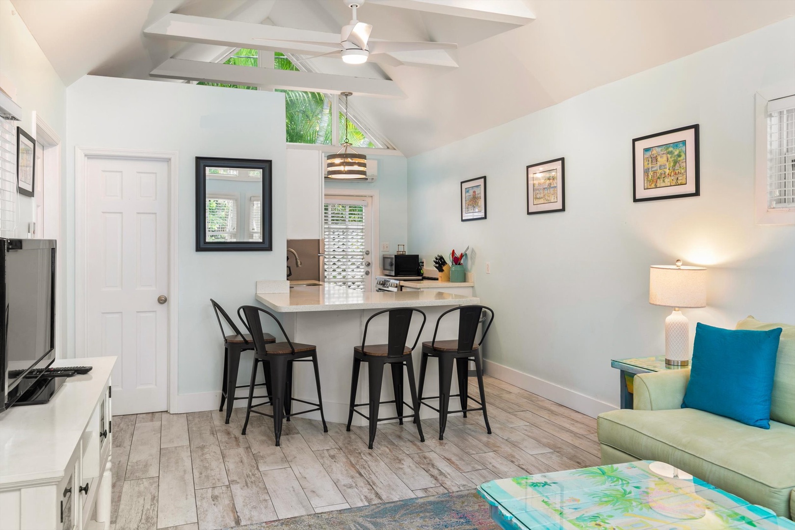 Bright, airy space where you can relax on the comfy sofa or gather at the breakfast bar. Vaulted ceilings, soft natural light, and cheerful coastal touches make this a perfect home base for your getaway.