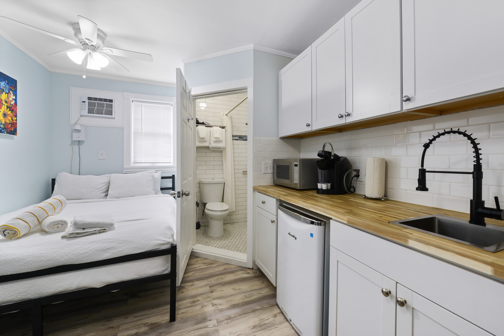 Matisse's Studio @ the Galleria Key West - Kitchenette Wall, Side of Queen Bed and Door to Bathroom