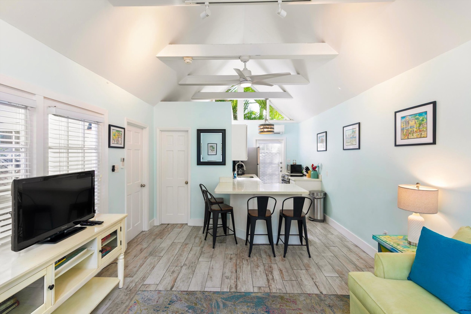 You'll love the bright, open layout of this charming cottage. The soaring vaulted ceiling with exposed beams creates an airy feel, while the cozy seating area invites you to unwind after a day of exploring.
