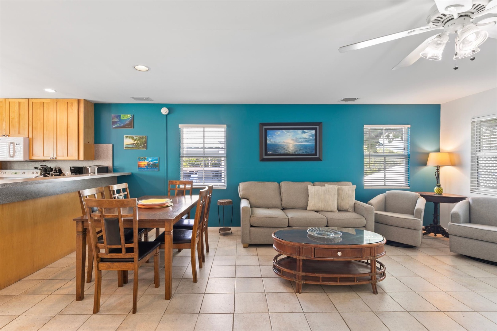 Step into your bright, open living space where coastal comfort meets home. Sink into the plush sofa, gather at the dining table, and feel the island breeze through your windows—your perfect retreat awaits.