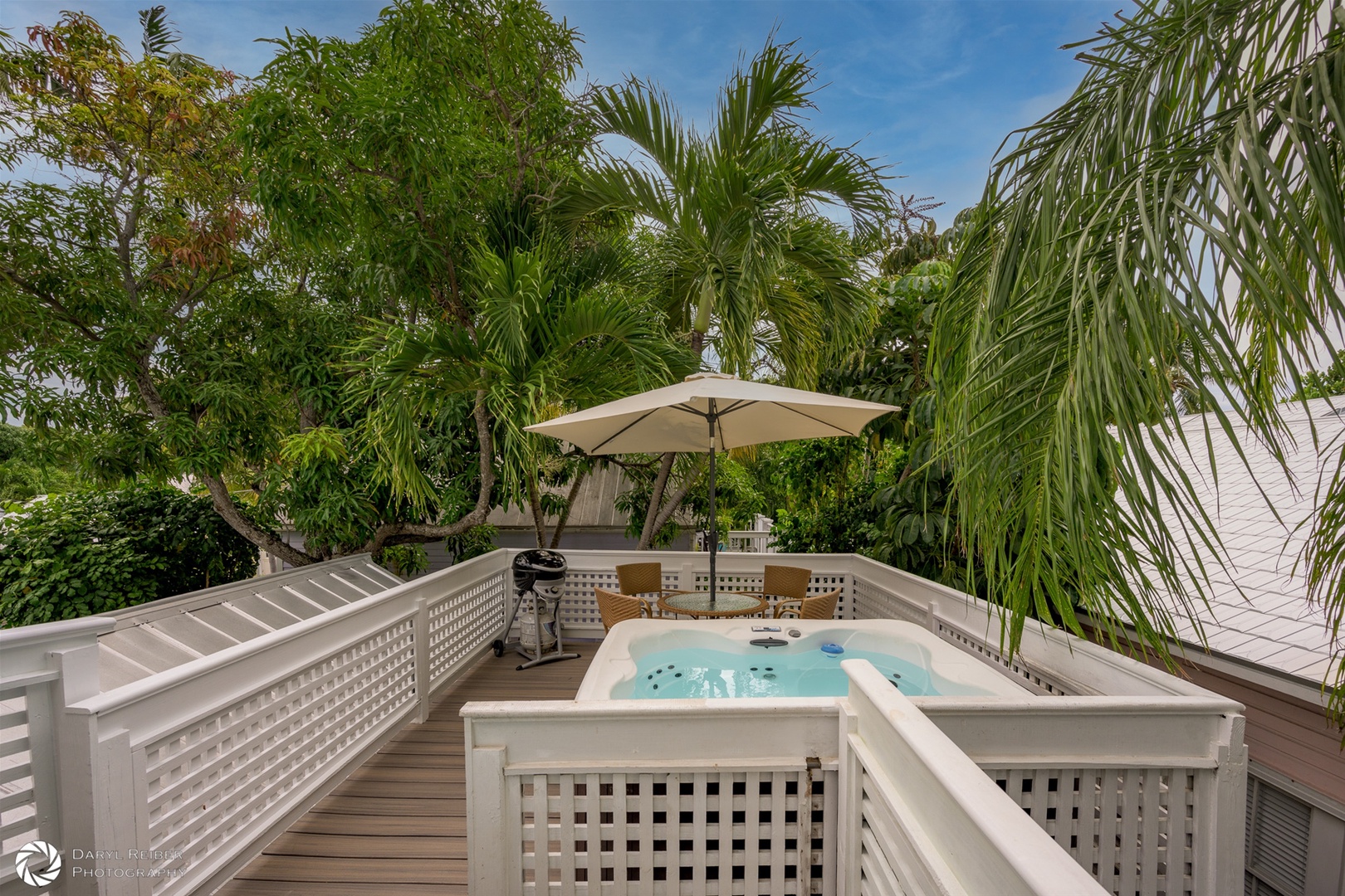 Private rooftop deck with hot tub, seating area and grill