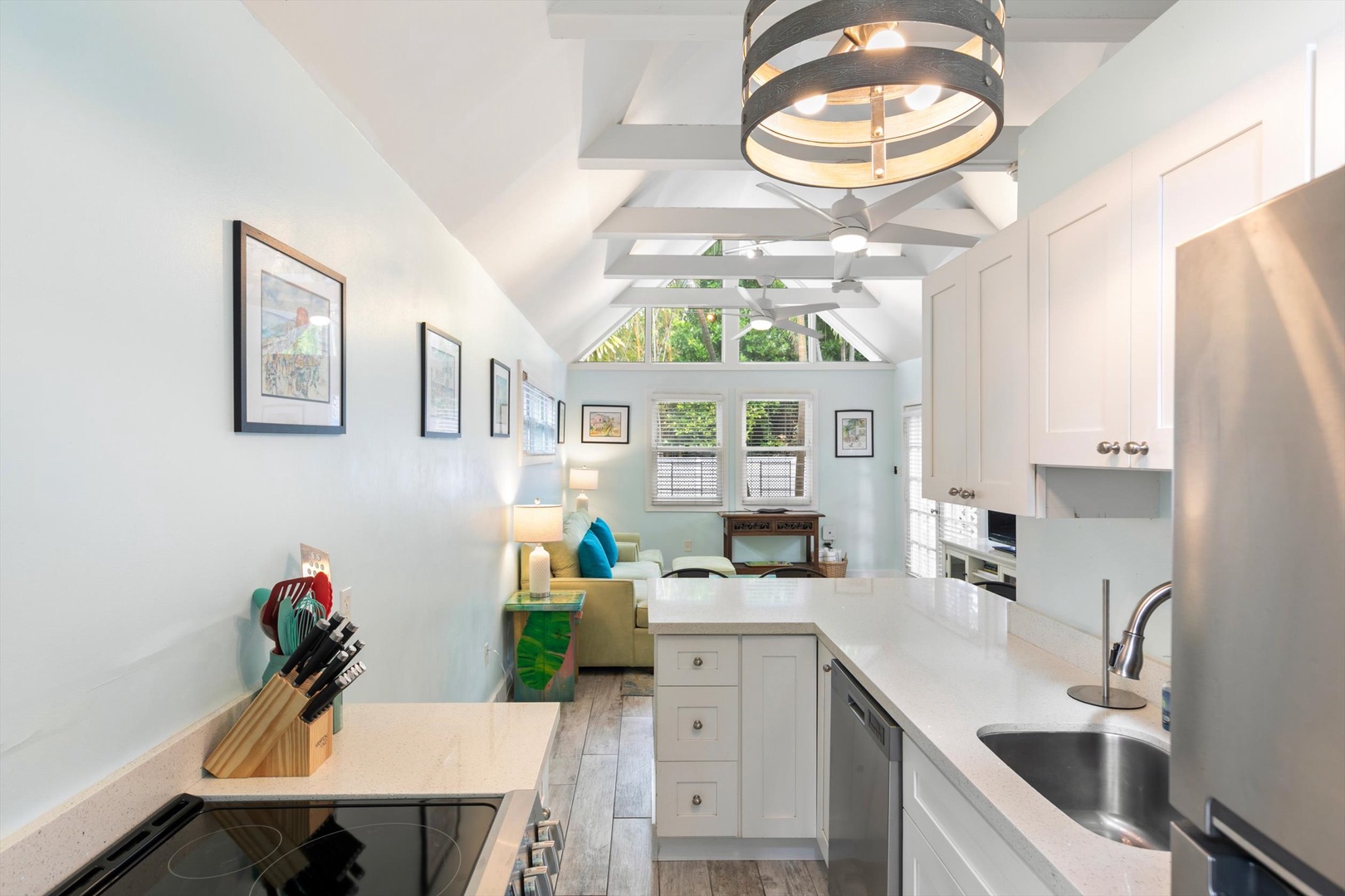 Step into your bright and airy retreat where modern appliances and vaulted ceilings create an inviting atmosphere. Natural light floods through the windows as you prepare meals in this fully-equipped space, perfect for your vacation stay.